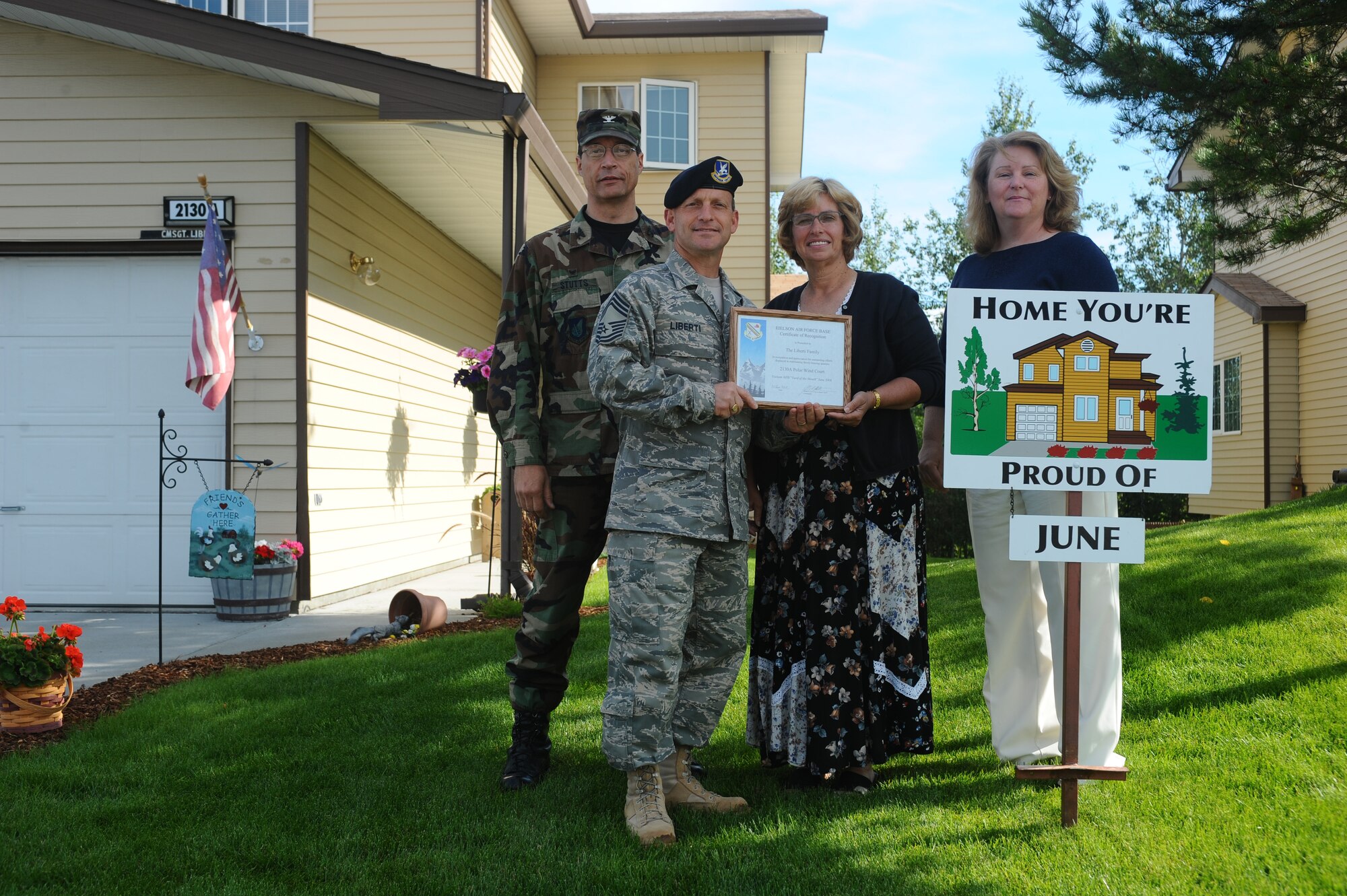 Chief Master Sgt. Nicholas Liberti and his spouse display their Home You're Proud Of award with Col. John Stutts, 354th Mission Support Group commander, and Lorie Dallas, 354th Civil Engineer Squadron military family housing, July 25, 2008 at Eielson Air Force Base, Alaska. They won the HYPO award for the month of June; each winning household received gift cards from various units on base and businesses off base. He is assigned to the 354th Security Forces Squadron. (U.S. Air Force photo by Airman 1st Class Jonathan Snyder)