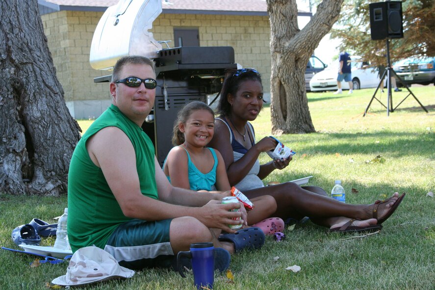 Staff Sgt. Chad Cowdery, 341st Logistics Readiness Squadron, and daughter Loreal and wife Renee, enjoy some family time under a tree at the Air Force Sergeants Association picnic July 26 at Sun Park Plaza.  The AFSA Chapter 1156 hosted a free pig roast and family picnic featuring music, an inflatable obstacle course and a barbeque grill raffle which raised more than $680 for the chapter. (U.S. Air Force photo/Senior Airman Eydie Sakura)