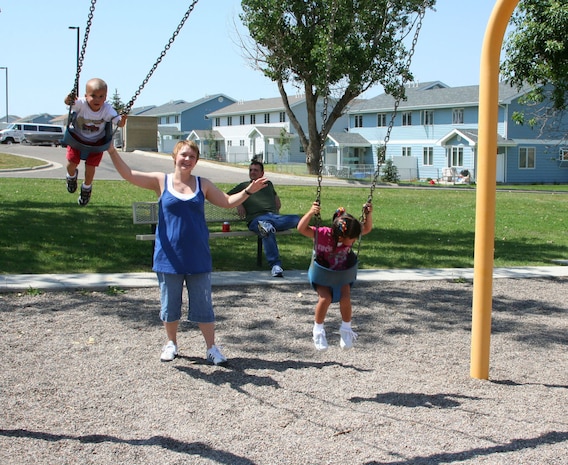 Staff Sgt. Mary Queen, 341st Medical Group, pushes Aric and Maddie, both 3, on the swings at the Air Force Sergeants Association picnic July 26 at Sun Park Plaza.  The AFSA Chapter 1156 hosted a free pig roast and family picnic featuring music, an inflatable obstacle course and a barbeque grill raffle which raised more than $680 for the chapter. (U.S. Air Force photo/Senior Airman Eydie Sakura)