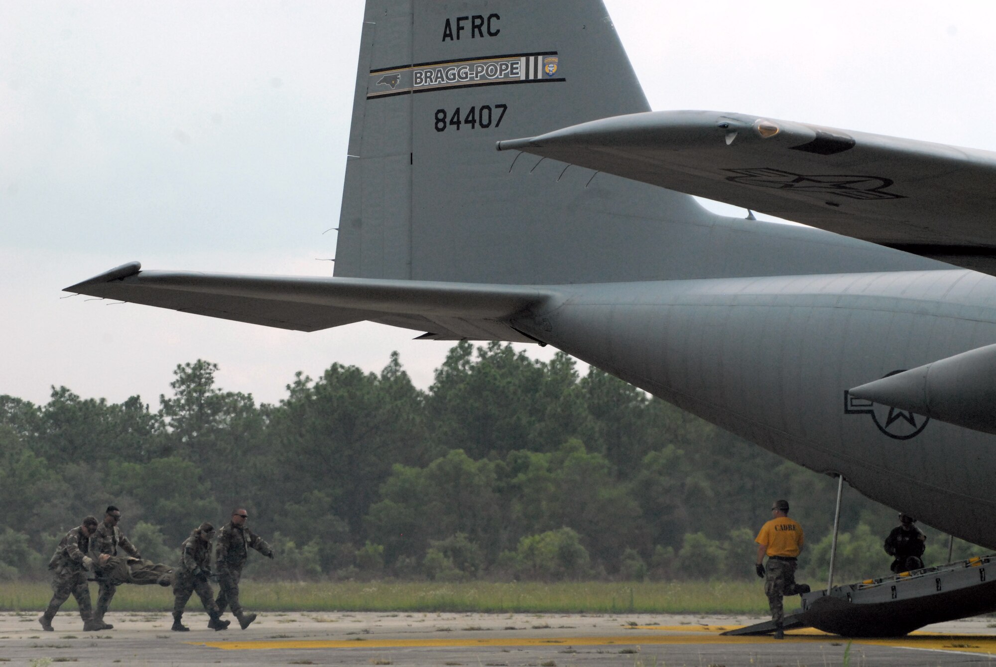 Airmen from the 60th Medical Group at Travis Air Force Base, Calif., load a litter on to a Pope Air Force Base C-130H Hercules during mobile aeromedical staging facility training at Fort Bragg's Camp Mackall, N.C., July 10. (U.S. Air Force photo/2nd Lt. Chris Hoyler)