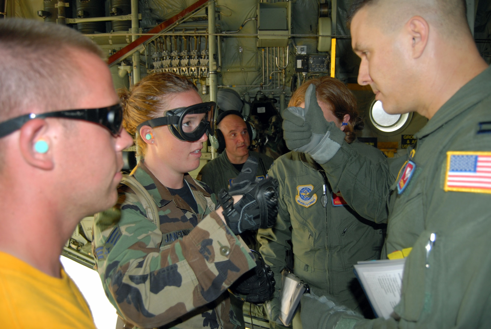 Capt. Stephen Urban explains the layout of the C-130H Hercules to Senior Airman Holly Jansenius during mobile aeromedical staging facility training at Fort Bragg's Camp Mackall, N.C., July 10. Captain Urban is assigned to the 375th Aeromedical Evacuation Squadron at Scott Air Force Base, Ill. Airman Jansenius is assigned to the , 60th Inpatient Operations Squadron at Travis AFB, Calif. (U.S. Air Force photo/Staff Sgt. Jon LaDue) 