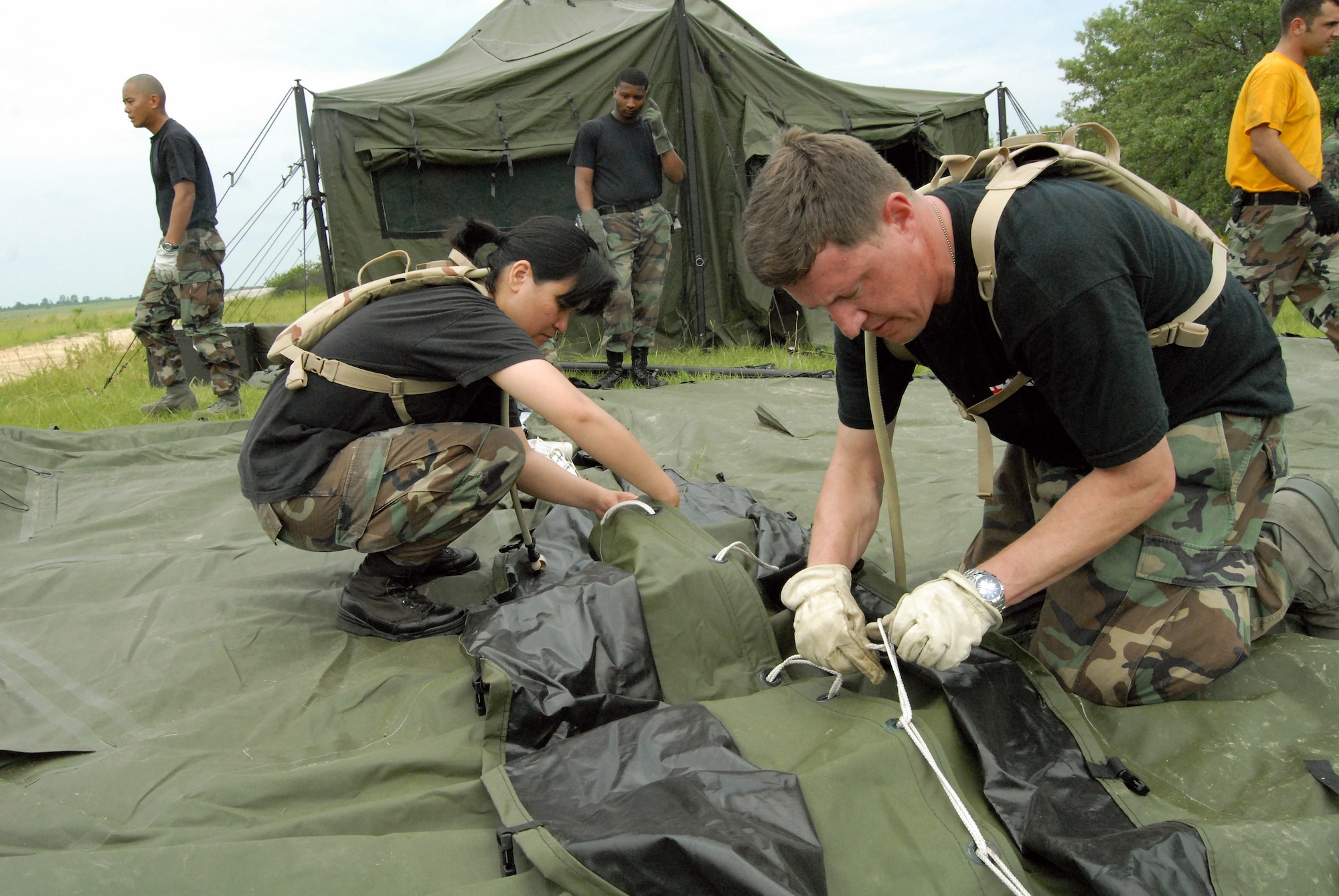 Maj. Maryann Marquez and Master Sgt. Benjamin Kratzer construct a second tent as part of their training with 43rd Aeromedical Evacuation Squadron at Pope Air Force Base, N.C., July 8. The week-long training gave the Airmen from 60th Medical Group at Travis AFB, Calif., the experience as part of a mobile aeromedical staging facility before they deploy. Major Marquez is and Sergeant Kratzer are assigned to the 60th Medical Support Squadron at Travis Air Force Base, Calif. (U.S. Air Force photo/2nd Lt. Chris Hoyler)