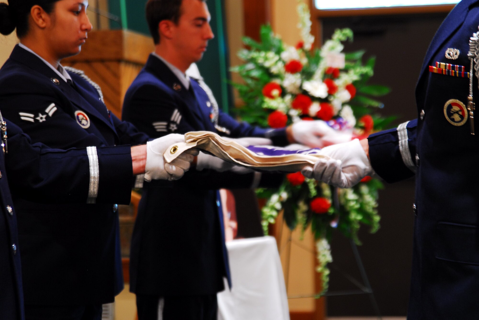 Members of the Hurlburt Field Honor Guard fold the flag during the memorial service for Staff Sgt. James Willis at the Hurlburt Field Chapel July 29. Sergeant Willis, who was assigned to the 4th Aircraft Maintenance Unit, died July 19 after being struck by lightning. (U.S. Air Force photo/Senior Airman Sheila deVera)