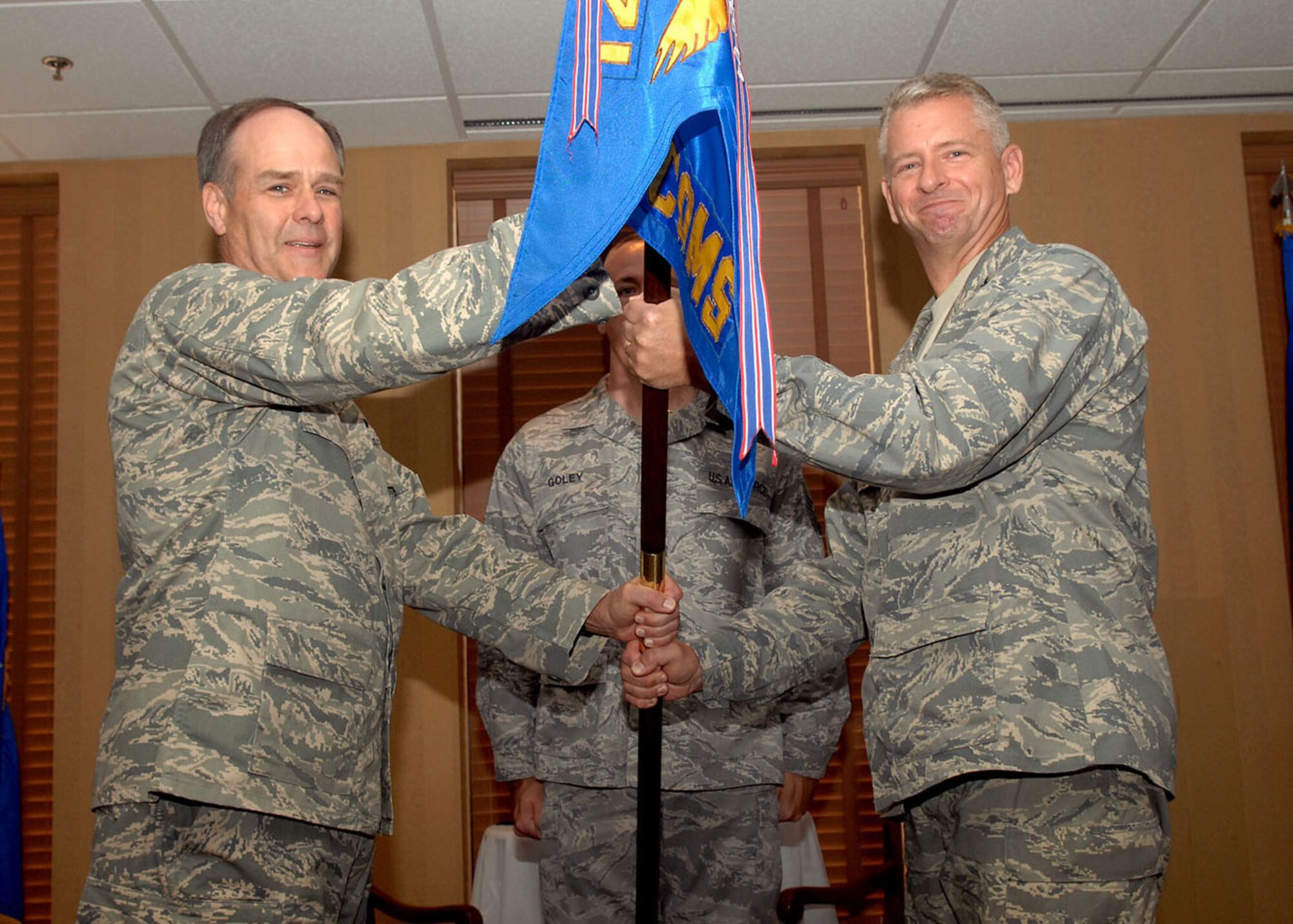 Col. Mark Kross (right) receives the 612th Air Communications Squadron guidon from the Brig.Gen. Joseph Mudd Jr., 12th Air Force (Air Forces Southern) vice commander, during an assumption of command ceremony here July 28. Colonel Kross assumed command of the 612th ACOMS after serving as the Commander of the 26th Network Operations Group, Lackland Air Force Base, San Antonio. (U.S. Air Force Base photo by Senior Airman Jacqueline Romero)