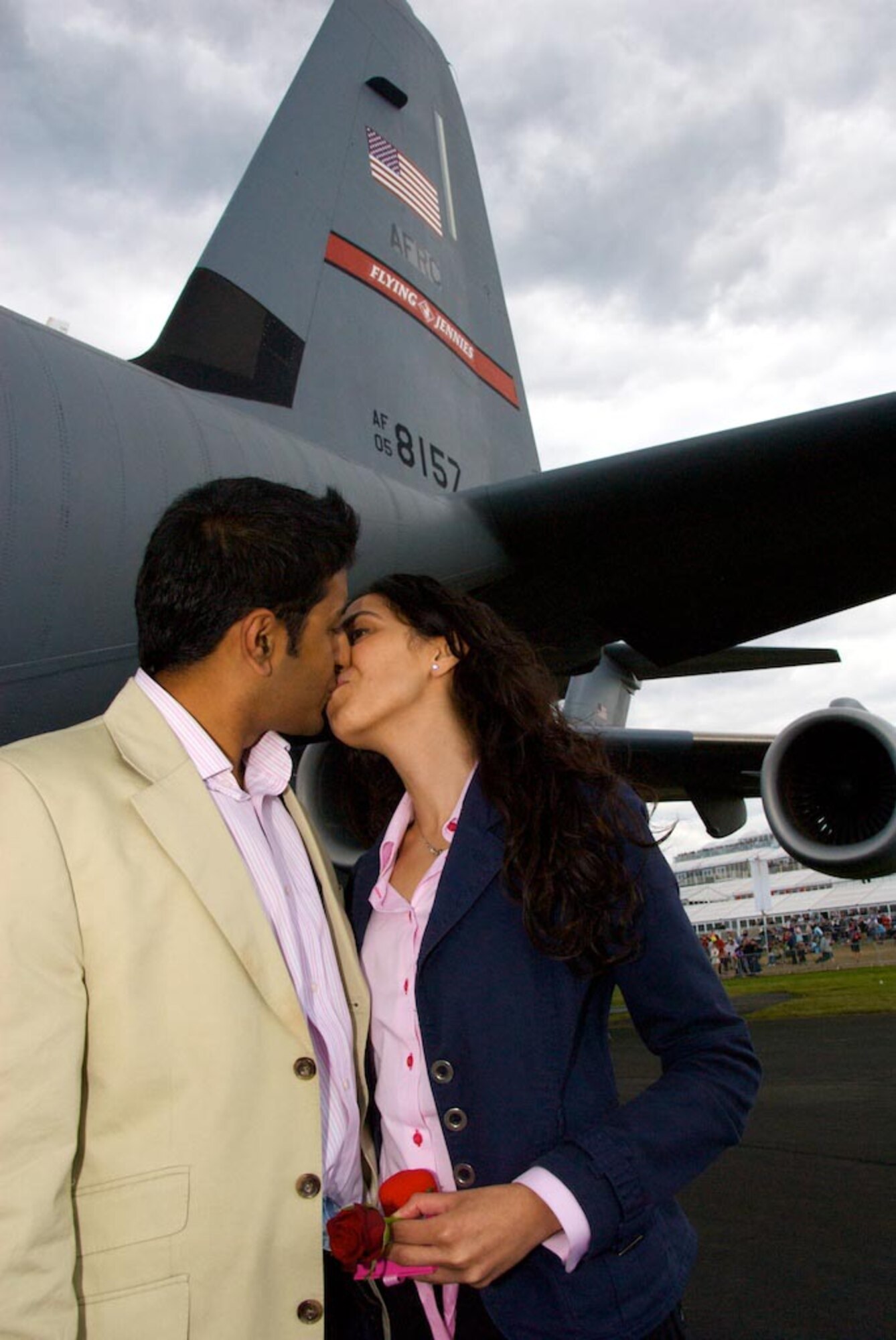 FARNBOROUGH, England -- Nitan Vadher and Seema Chudasama seal their engagement with a kiss beside aircraft No. 8157. Mr. Vadher proposed to Ms. Chudasama on the flight deck of the C-130J "Flying Jennies" aircraft July 20, 2008, during the Farnborough Air Show in England. (U.S. Air Force photo/Maj. Chad E. Gibson)