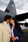 FARNBOROUGH, England -- Nitan Vadher and Seema Chudasama seal their engagement with a kiss beside aircraft No. 8157. Mr. Vadher proposed to Ms. Chudasama on the flight deck of the C-130J "Flying Jennies" aircraft July 20, 2008, during the Farnborough Air Show in England. (U.S. Air Force photo/Maj. Chad E. Gibson)