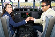 FARNBOROUGH, England -- Nitan Vadher gives a rose to Seema Chudasama on the flight deck of a C-130J during the Farnborough Air Show 2008 in England. The 403rd Wing's 815th Airlift Squadron showcased the unique capabilities of the plane at the largest air show in the world July 13-20, 2008. (U.S. Air Force photo/Maj. Chad E. Gibson)
