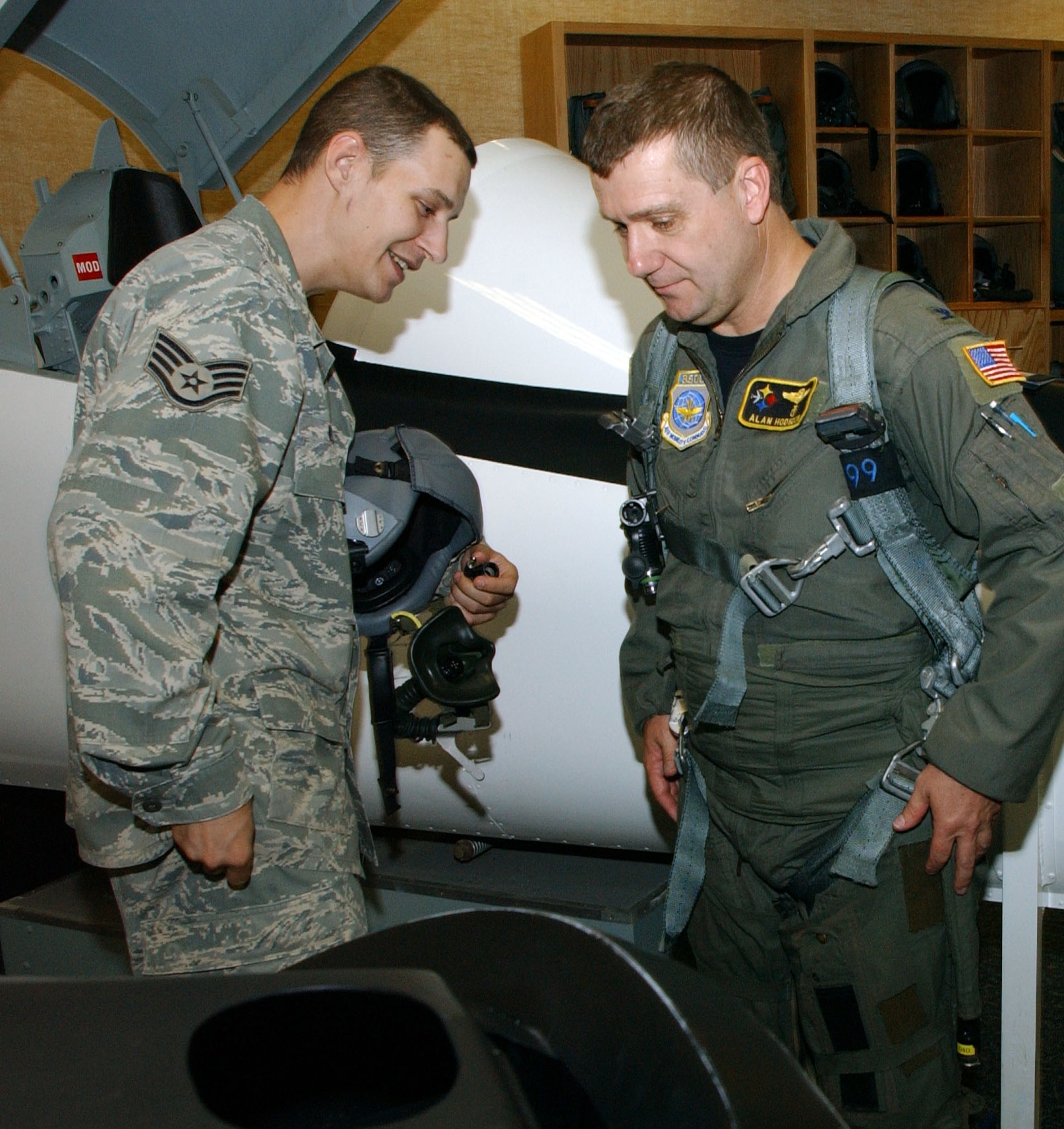 Col. Alan Hodgdon, one of 12 Air Force flight surgeons who are also pilots, receives T-6 egress training, July 25, from Staff Sgt. David Webb with the 71st Medical Operations Squadron’s Aerospace Physiology Flight here. Colonel Hodgdon is the Medical Group commander with the 171st Air Refueling Wing, Pennsylvania Air National Guard, Pittsburgh International Airport Air Reserve Station, Pa. He was a T-37 instructor pilot at Laughlin AFB, Texas, from 1978 until 1984. Colonel Hodgdon also flew F-4s while attending medical school. All flight surgeons have required flight time, half of which can be with aircraft outside their home unit. Colonel Hodgdon’s son, 2nd Lt. Benjamin Hodgdon, is a student in Class 090-06 here. (U.S. Air Force photo by Joe B. Wiles)