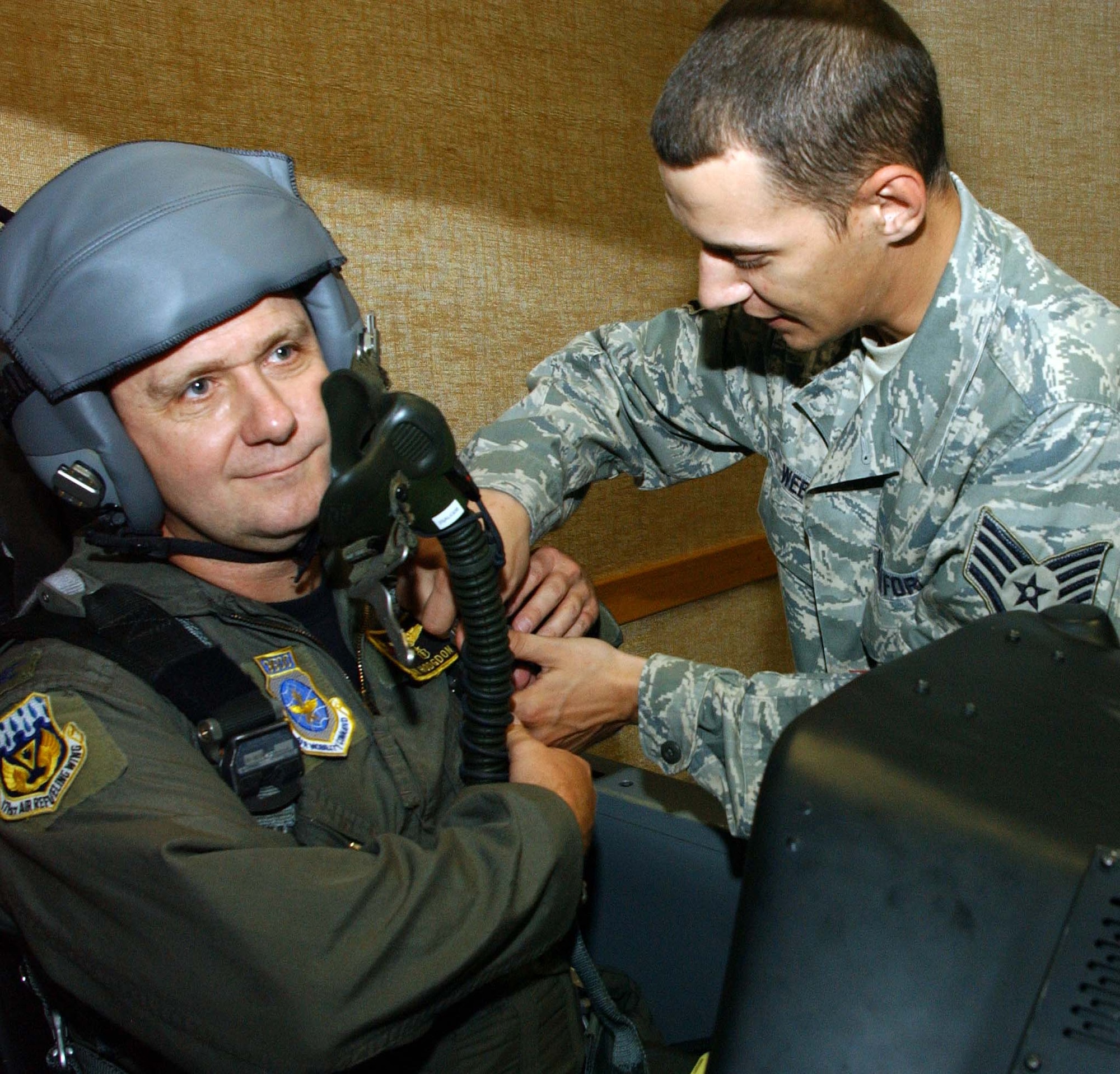 Col. Alan Hodgdon, one of 12 Air Force flight surgeons who are also pilots, receives T-6 egress training, July 25, from Staff Sgt. David Webb with the 71st Medical Operations Squadron’s Aerospace Physiology Flight here. Colonel Hodgdon is the Medical Group commander with the 171st Air Refueling Wing, Pennsylvania Air National Guard, Pittsburgh International Airport Air Reserve Station, Pa. He was a T-37 instructor pilot at Laughlin AFB, Texas, from 1978 until 1984. Colonel Hodgdon also flew F-4s while attending medical school. All flight surgeons have required flight time, half of which can be with aircraft outside their home unit. Colonel Hodgdon’s son, 2nd Lt. Benjamin Hodgdon, is a student in Class 090-06 here. (U.S. Air Force photo by Joe B. Wiles)