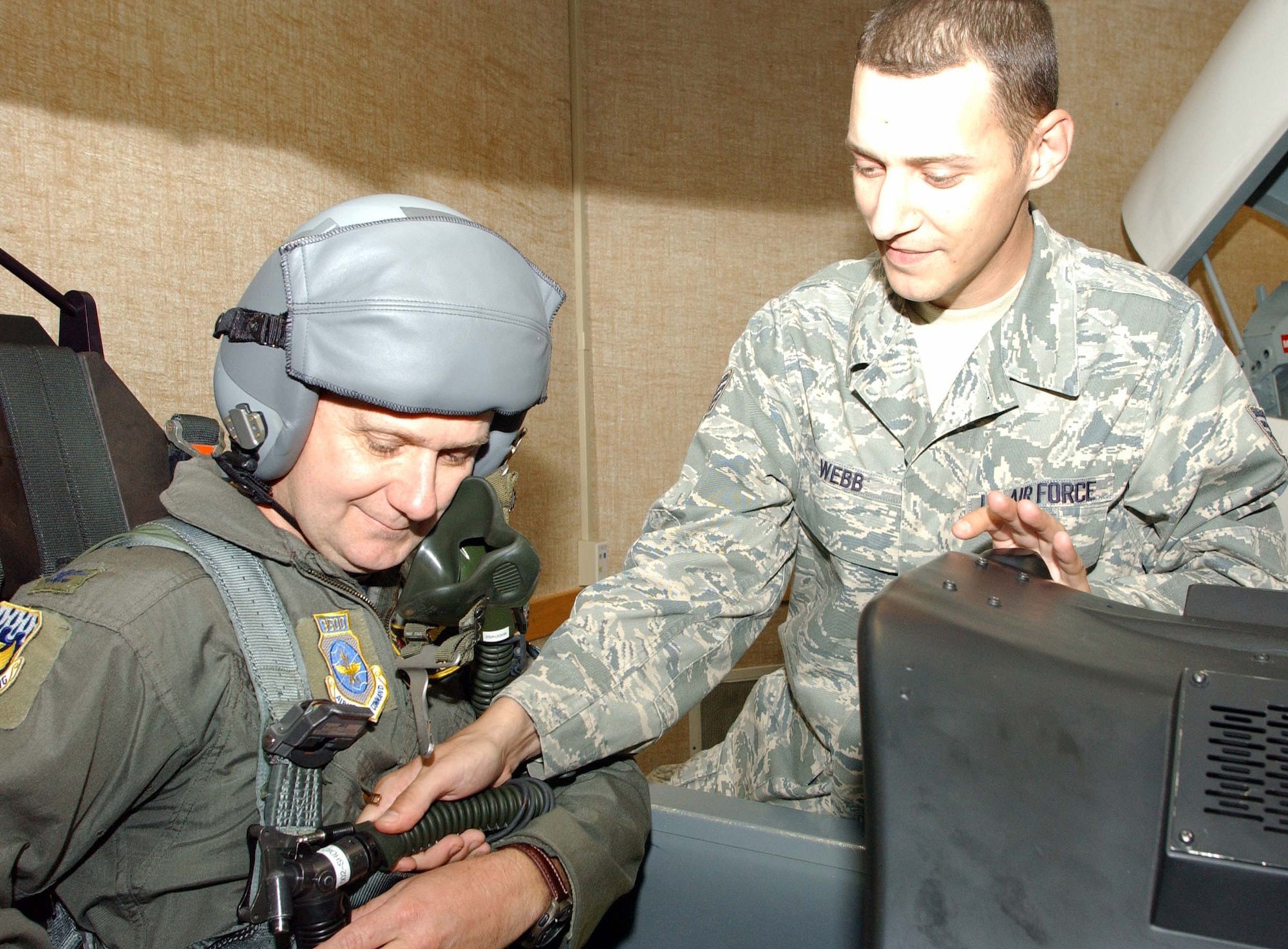 Col. Alan Hodgdon, one of 12 Air Force flight surgeons who are also pilots, receives T-6 egress training, July 25, from Staff Sgt. David Webb with the 71st Medical Operations Squadron’s Aerospace Physiology Flight here. Colonel Hodgdon is the Medical Group commander with the 171st Air Refueling Wing, Pennsylvania Air National Guard, Pittsburgh International Airport Air Reserve Station, Pa. He was a T-37 instructor pilot at Laughlin AFB, Texas, from 1978 until 1984. Colonel Hodgdon also flew F-4s while attending medical school. All flight surgeons have required flight time, half of which can be with aircraft outside their home unit. Colonel Hodgdon’s son, 2nd Lt. Benjamin Hodgdon, is a student in Class 090-06 here. (U.S. Air Force photo by Joe B. Wiles)