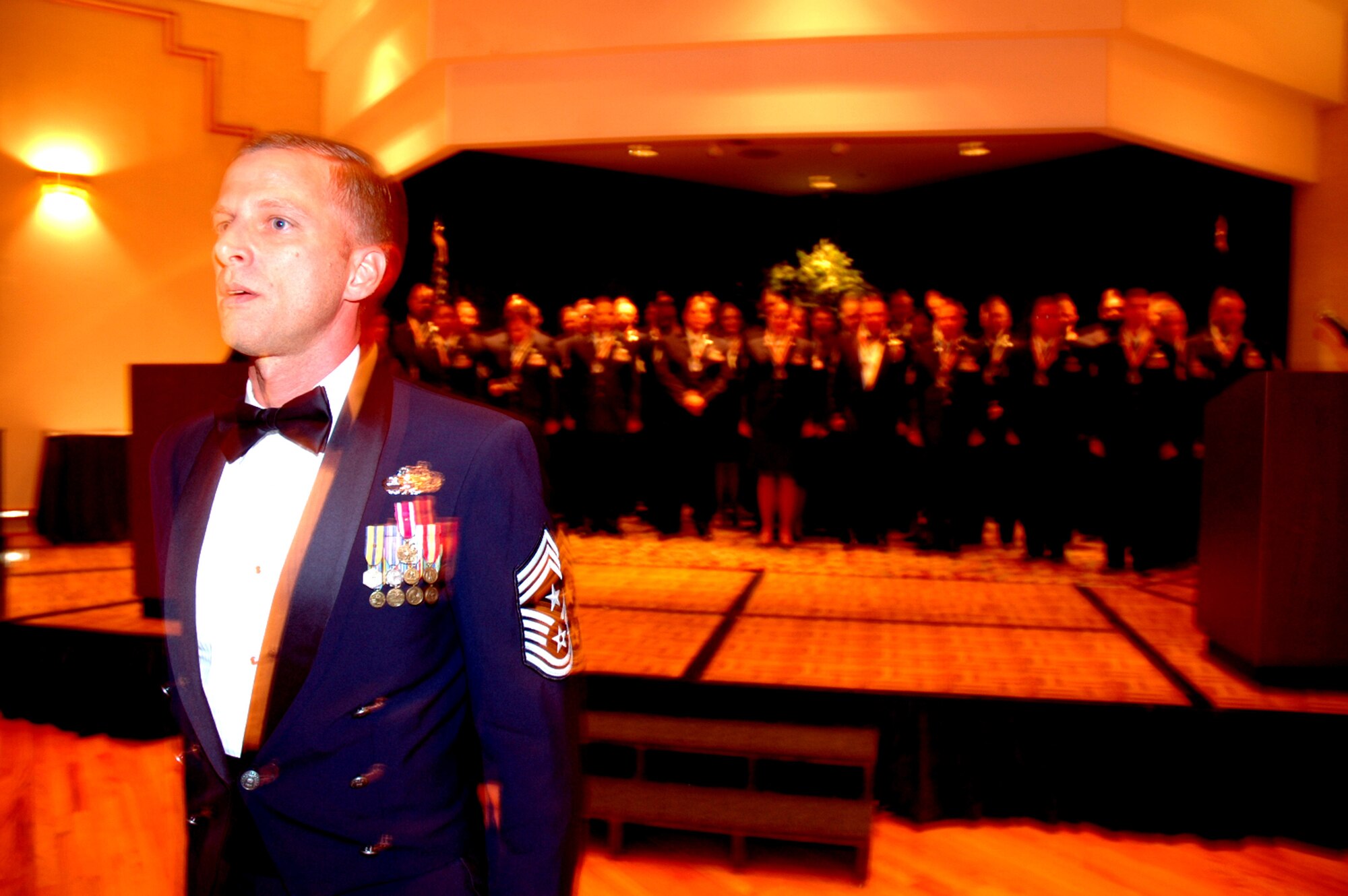 Chief Master Sgt. John Gillette, 305th Air Mobility Wing command chief master sergeant, leads more than 40 technical sergeants in reciting The Airman's Creed during the 2008 McGuire Senior NCO Induction Ceremony at the McGuire Air Force Base, N.J., Club July 25. The master sergeant-selects were recognized during the ceremony for being selected for master sergeant and their eventual inclusion into the Air Force senior NCO corps.  (U.S. Air Force Photo/Tech. Sgt. Scott T. Sturkol)