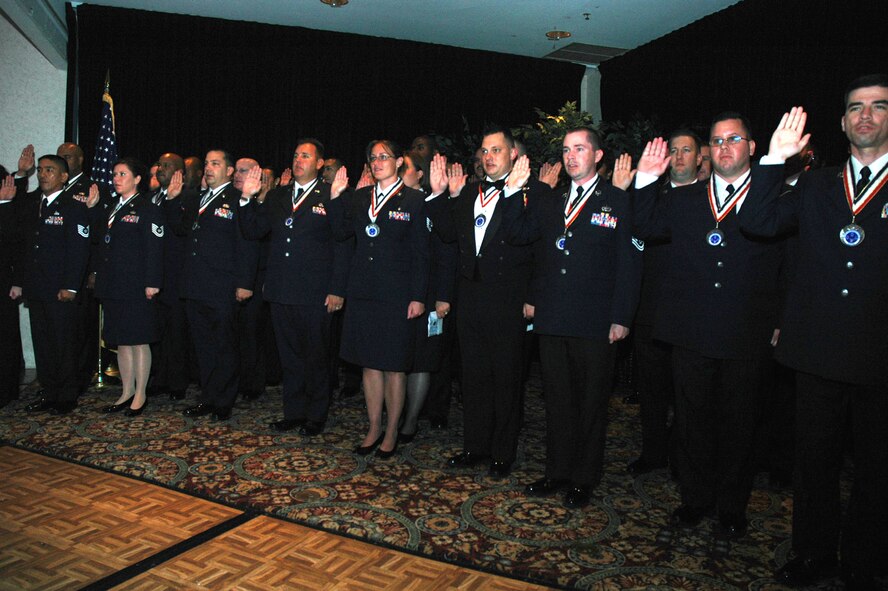 More than 40 technical sergeants recite the oath of enlistment during the 2008 McGuire Senior NCO Induction Ceremony at the McGuire Air Force Base, N.J., Club July 25. The master sergeant-selects were recognized during the ceremony for being selected for master sergeant and their eventual inclusion into the Air Force senior NCO corps.  (U.S. Air Force Photo/Tech. Sgt. Scott T. Sturkol)