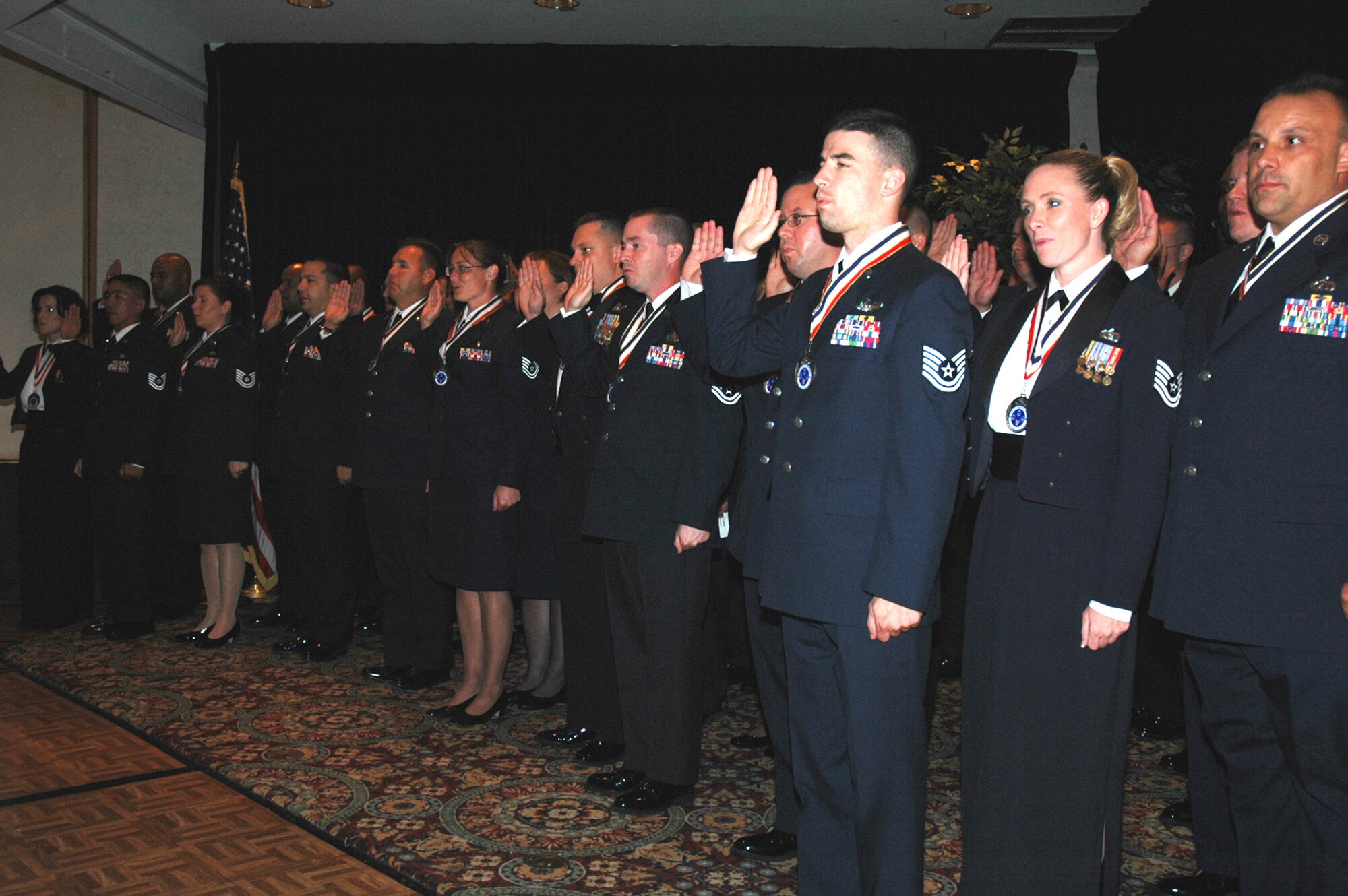 More than 40 technical sergeants recite the oath of enlistment during the 2008 McGuire Senior NCO Induction Ceremony at the McGuire Air Force Base, N.J., Club July 25. The master sergeant-selects were recognized during the ceremony for being selected for master sergeant and their eventual inclusion into the Air Force senior NCO corps.  (U.S. Air Force Photo/Tech. Sgt. Scott T. Sturkol)