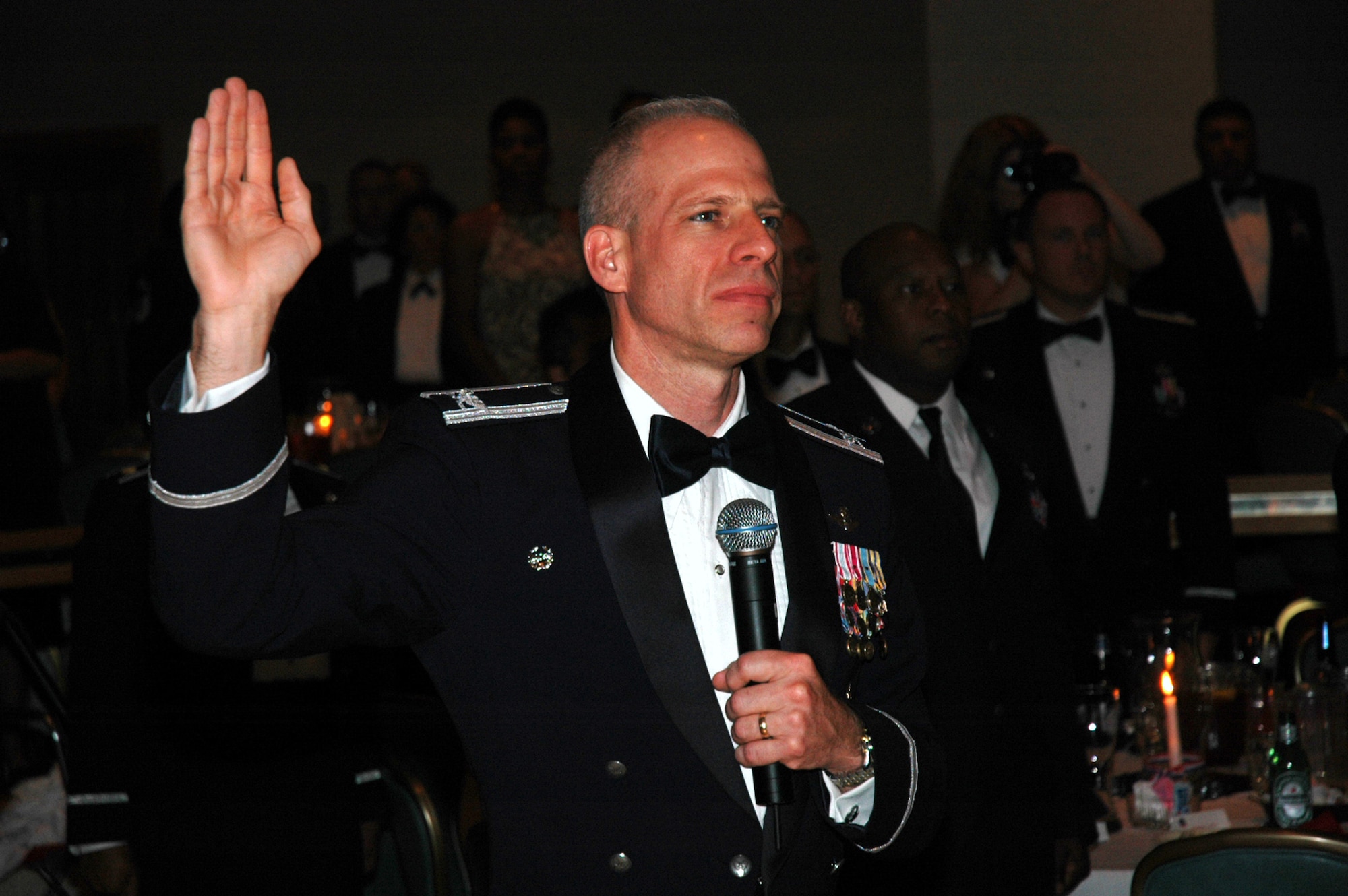 Col. Scott Hill, 305th Operations Group commander, leads the oath of enlistment for more than 40 technical sergeants selected for master sergeant during the 2008 McGuire Senior NCO Induction Ceremony at the McGuire Air Force Base, N.J., Club July 25.  (U.S. Air Force Photo/Tech. Sgt. Scott T. Sturkol)