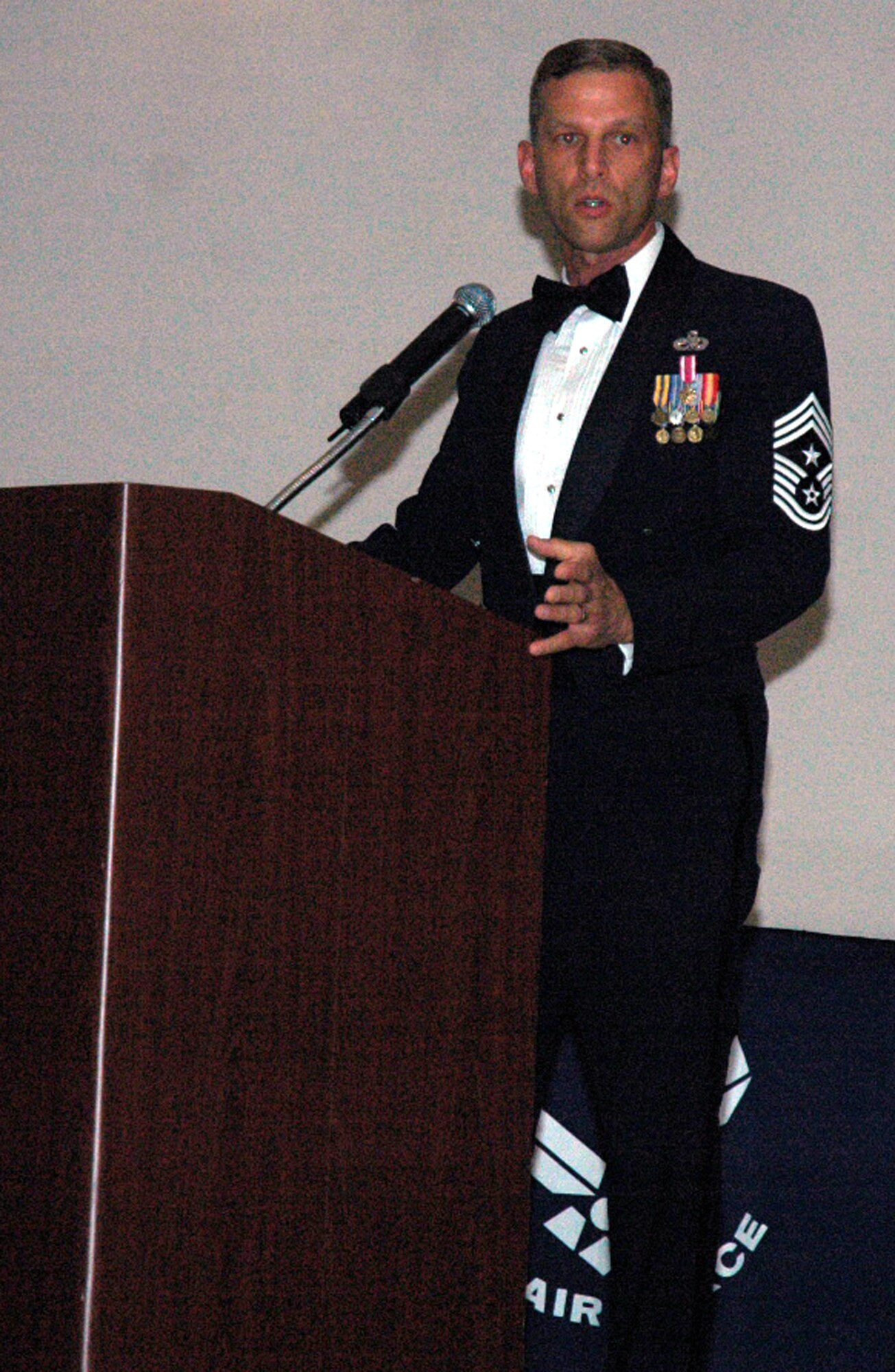 Chief Master Sgt. John Gillette, 305th Air Mobility Wing command chief master sergeant, speaks during the 2008 McGuire Senior NCO Induction Ceremony July 25 at the McGuire Air Force Base, N.J., Club. Tech. Sgt. Sue Parker and her husband Chuck pass under the saber cordon during the 2008 McGuire Senior NCO Induction Ceremony July 25 at the McGuire Air Force Base, N.J., Club.  More than 40 technical sergeants were recognized during the ceremony for being selected for master sergeant and their eventual inclusion into the Air Force senior NCO corps. (U.S. Air Force Photo/Tech. Sgt. Scott T. Sturkol)