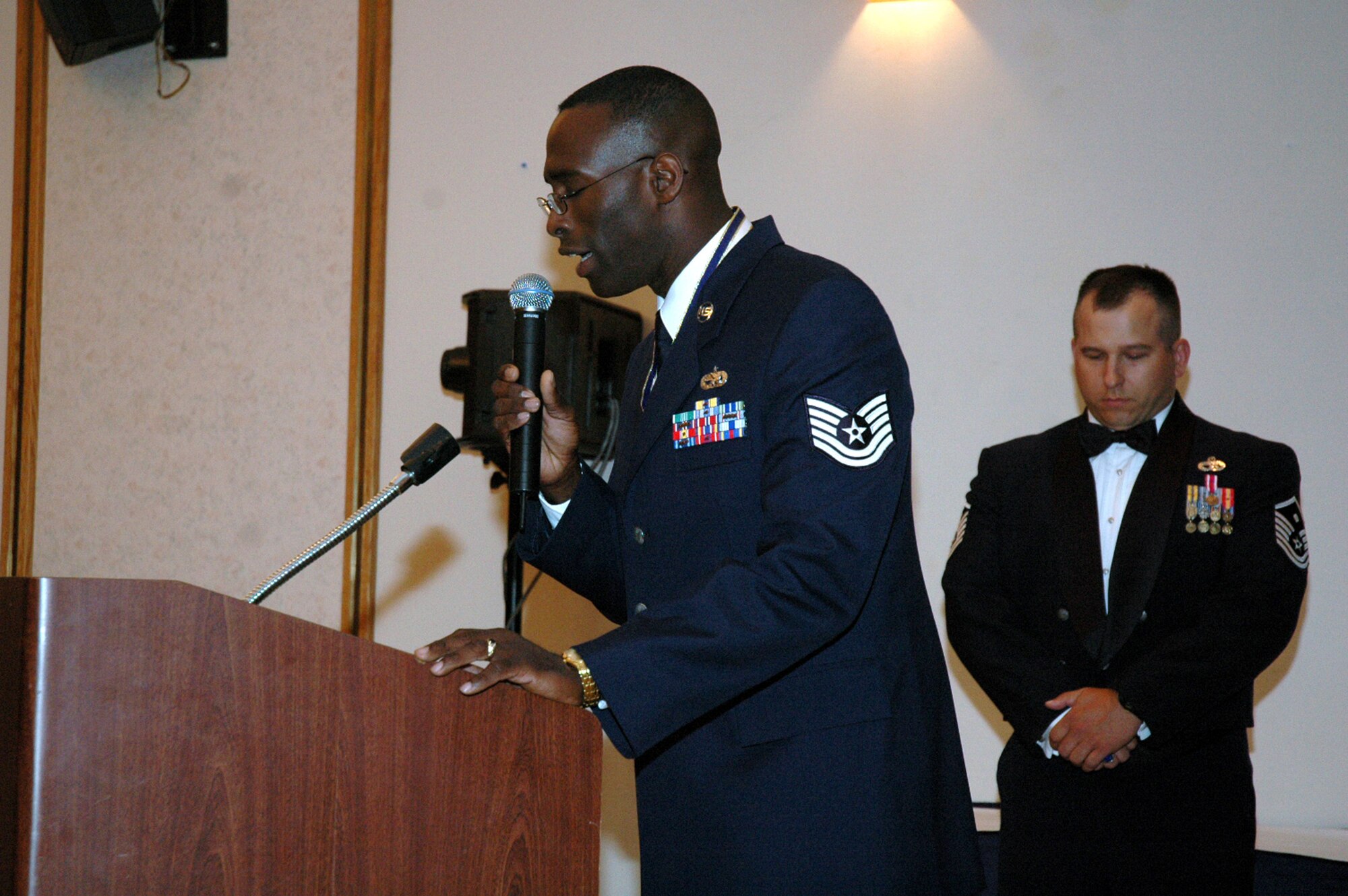 Tech. Sgt. Floyd Grant, 819th Global Support Squadron, gives the invocation during the start of the 2008 McGuire Senior NCO Induction Ceremony July 25 at the McGuire Air Force Base, N.J., Club.  More than 40 technical sergeants, including Sergeant Floyd, were recognized during the ceremony for being selected for master sergeant and their eventual inclusion into the Air Force senior NCO corps.  (U.S. Air Force Photo/Tech. Sgt. Scott T. Sturkol)
