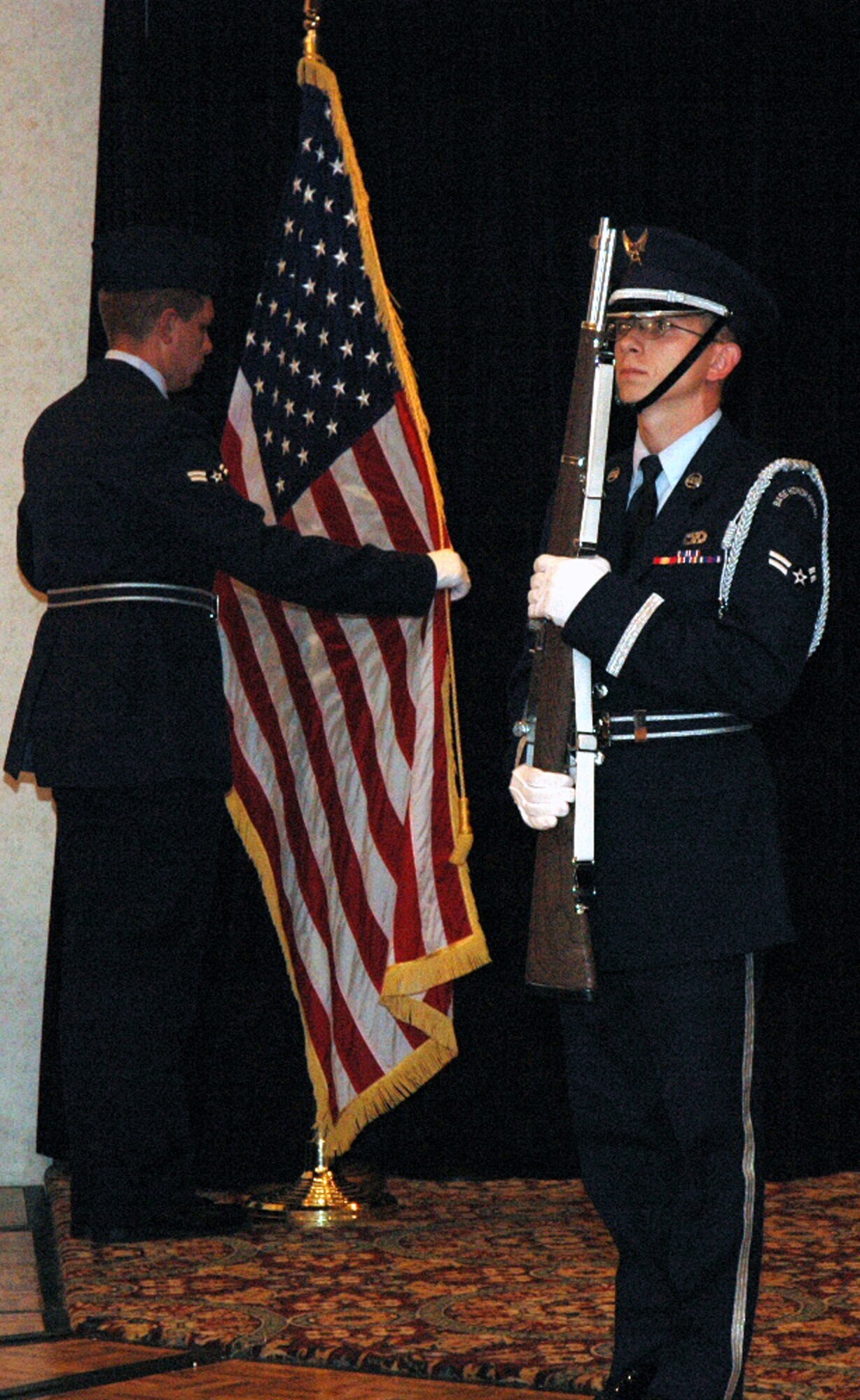 Members of the McGuire Air Force Base, N.J., Honor Guard post the colors during the start of the 2008 McGuire Senior NCO Induction Ceremony July 25 at the McGuire Club.  More than 40 technical sergeants were recognized during the ceremony for being selected for master sergeant and their eventual inclusion into the Air Force senior NCO corps.  (U.S. Air Force Photo/Tech. Sgt. Scott T. Sturkol)