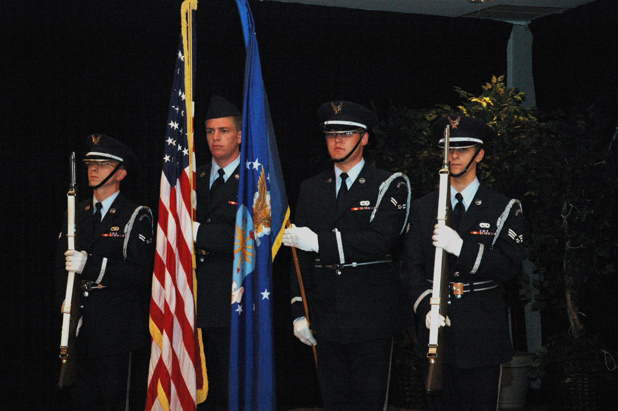 Members of the McGuire Air Force Base, N.J., Honor Guard stand at "present arms" during the singing of the national anthem and the start of the 2008 McGuire Senior NCO Induction Ceremony July 25 at the McGuire Club.  More than 40 technical sergeants were recognized during the ceremony for being selected for master sergeant and their eventual inclusion into the Air Force senior NCO corps.  (U.S. Air Force Photo/Tech. Sgt. Scott T. Sturkol)
