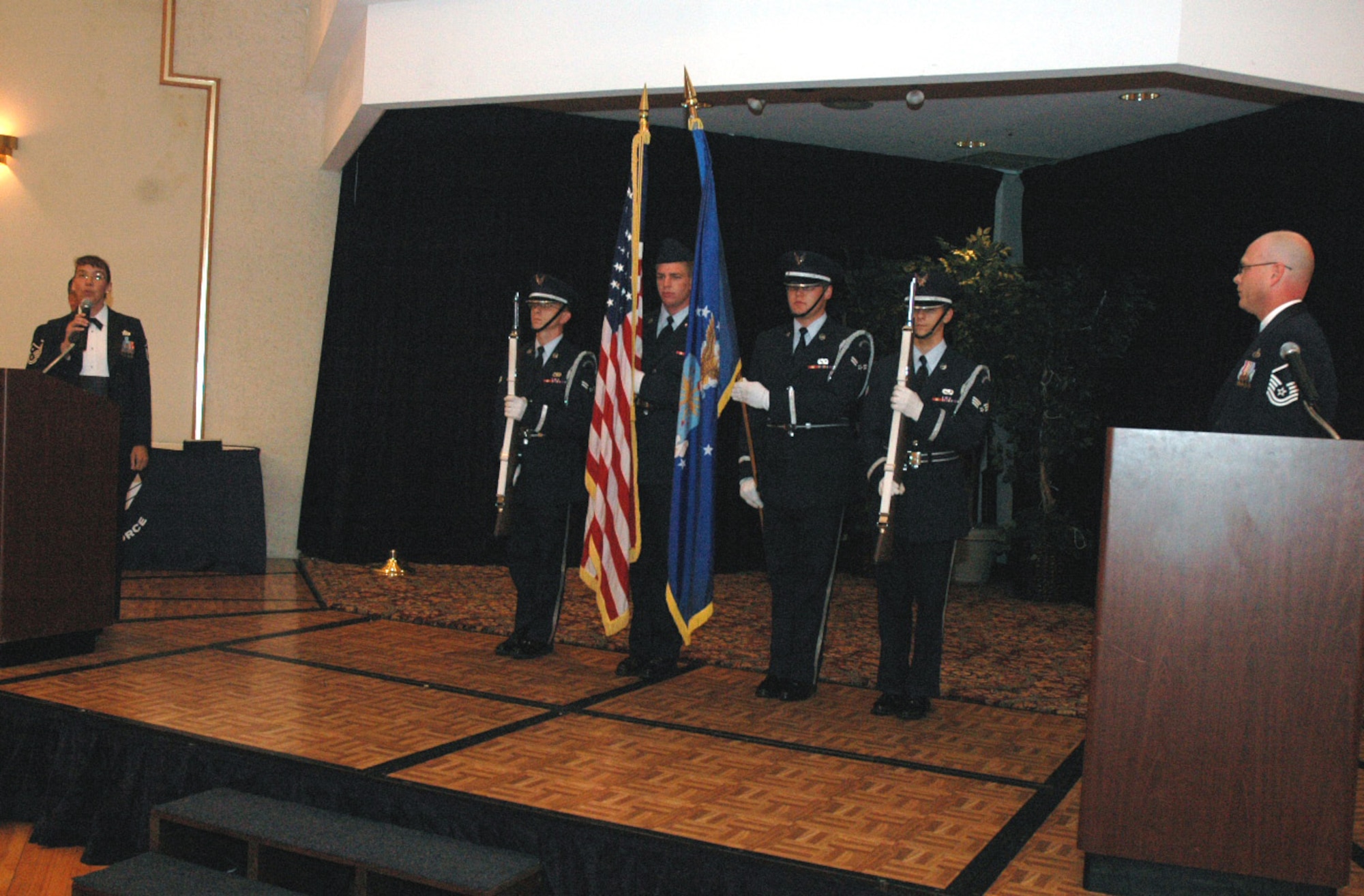 Master Sgt. Martha Meador, 305th Air Mobility Wing, sings the national anthem while members of the McGuire Air Force Base, N.J., Honor Guard "present arms" during the start of the 2008 McGuire Senior NCO Induction Ceremony July 25 at the McGuire Club.  More than 40 technical sergeants were recognized during the ceremony for being selected for master sergeant and their eventual inclusion into the Air Force senior NCO corps.  (U.S. Air Force Photo/Tech. Sgt. Scott T. Sturkol)