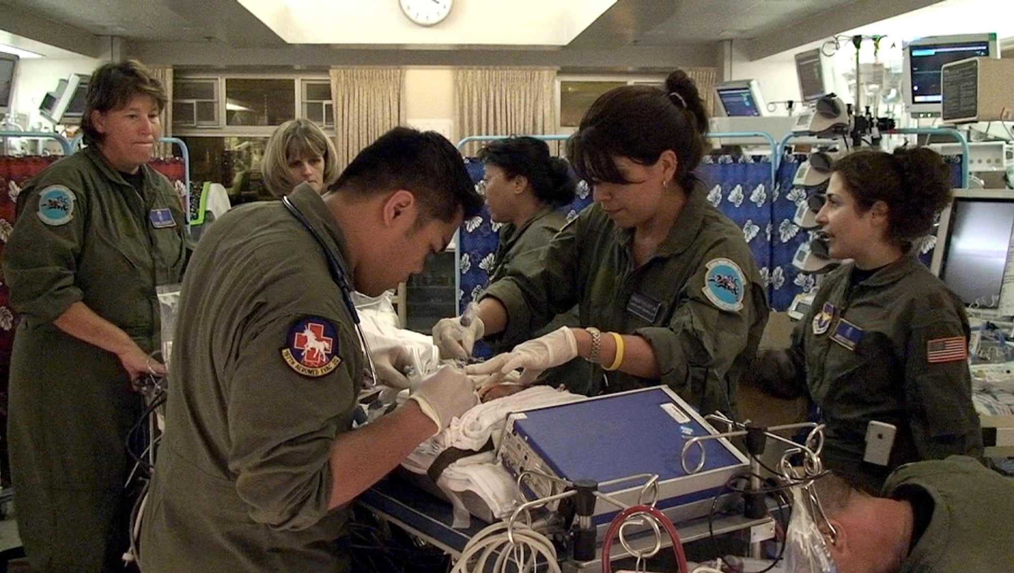 The Wilford Hall Medical Center's extra corporeal membrane oxygenation team stabilizes the infant on the ECMO transport cart in the neonatal intensive care unit at Kapiolani Medical Center in Honolulu July 22. The ECMO team flew to Hawaii to transport the critically ill infant to Rady Children's Hospital in California for advanced medical treatment. Left to right, NICU Respiratory Therapist Airman 1st Class Andrew Pamintuan, 59th Medical Operations Squadron, senior ECMO coordinator Cheryl Collicott, 59th Medical Inpatient Squadron, Neonatal Fellow Capt. (Dr.) Jennifer Pirato, 59th Maternal/Child Care Squadron, Nurses Aida Yumol, Bernadette Elliott, 59th MDIS, Maj. (Dr.) Melissa Tyree, 59th MCCS, Nurse Capt. Terry Bailey, 59th MDIS. (U.S. Air Force photo/Maj. Kreangkai Tyree)