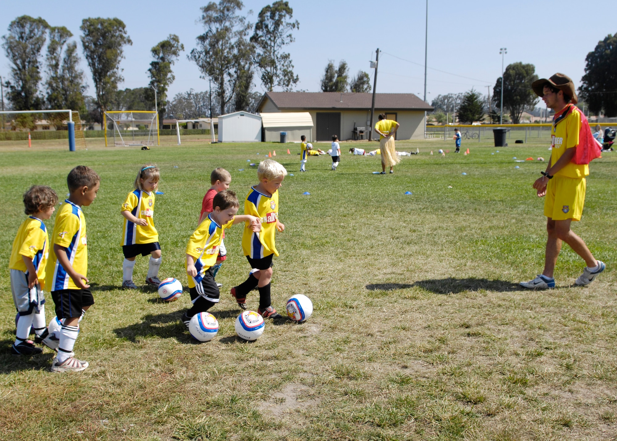 VANDENBERG AIR FORCE BASE, Calif. -- A coach with the Challenger Sports Soccer Camp here gives instruction to a group of children Friday. (U.S. Air Force photo / Airman 1st Class Heather Shaw)