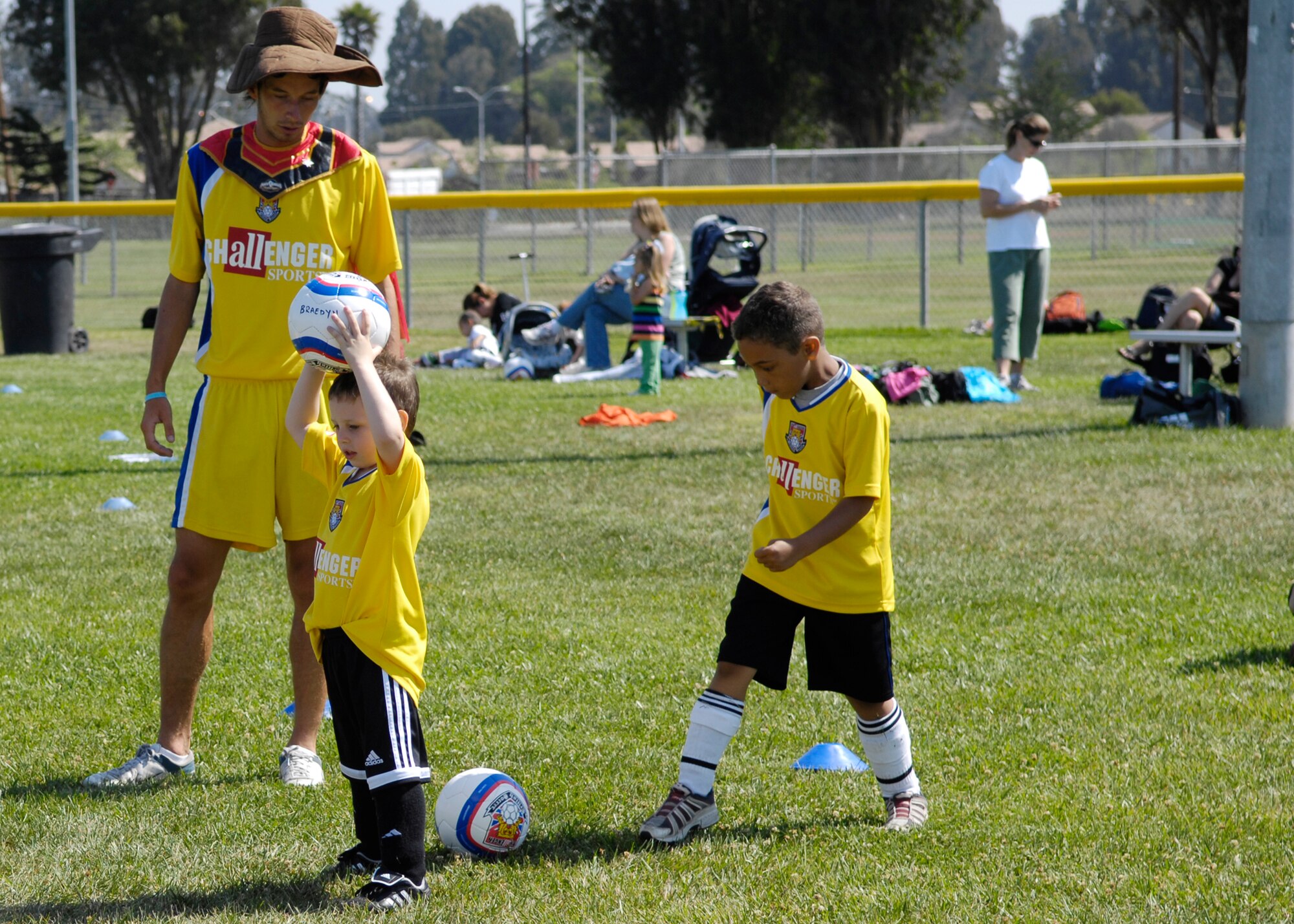 VANDENBERG AIR FORCE BASE, Calif. --  A coach with the Challenger Sports Soccer Camp here gives instruction to a group of children Friday. (U.S. Air Force photo / Airman 1st Class Heather Shaw)