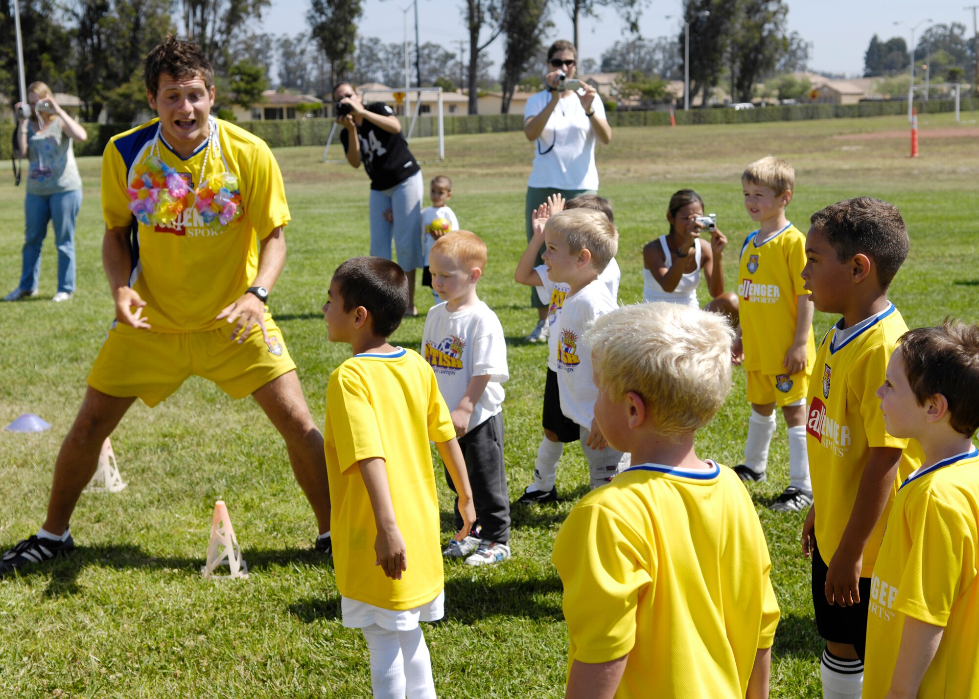 VANDENBERG AIR FORCE BASE, Calif. --  A coach with the Challenger Sports Soccer Camp here gives instruction to a group of children Friday. (U.S. Air Force photo / Airman 1st Class Heather Shaw)