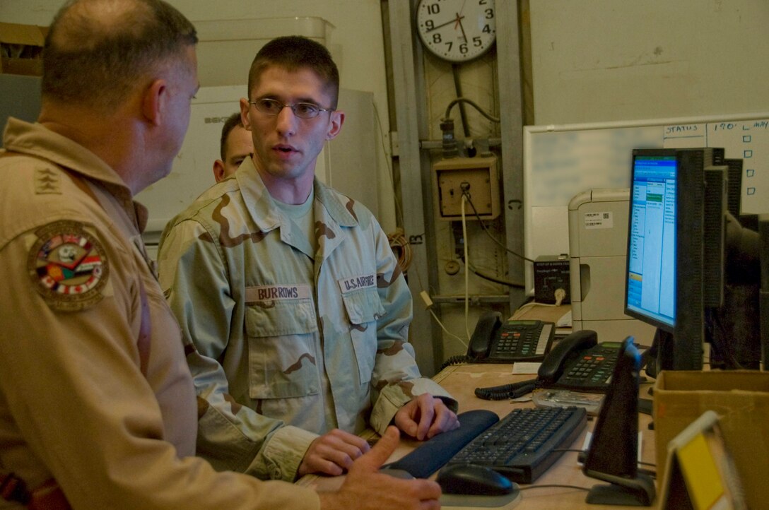 ALI BASE, Iraq -- Airman Christopher Burrows explains to Lt. Gen. Gary North a process used by the supply unit here to make workflow more fluid. General North visited Ali Base, Iraq, July 28 to see recent improvements and to thank Airmen for their service to their country. Airman Burrows is assigned to the 407th Expeditionary Logistics Readiness Squadron and is deployed from Ellsworth Air Force Base, S.D. General North is the commander of 9th Air Force and U.S. Air Forces Central. (U.S. Air Force photo/Airman 1st Class Christopher Griffin)