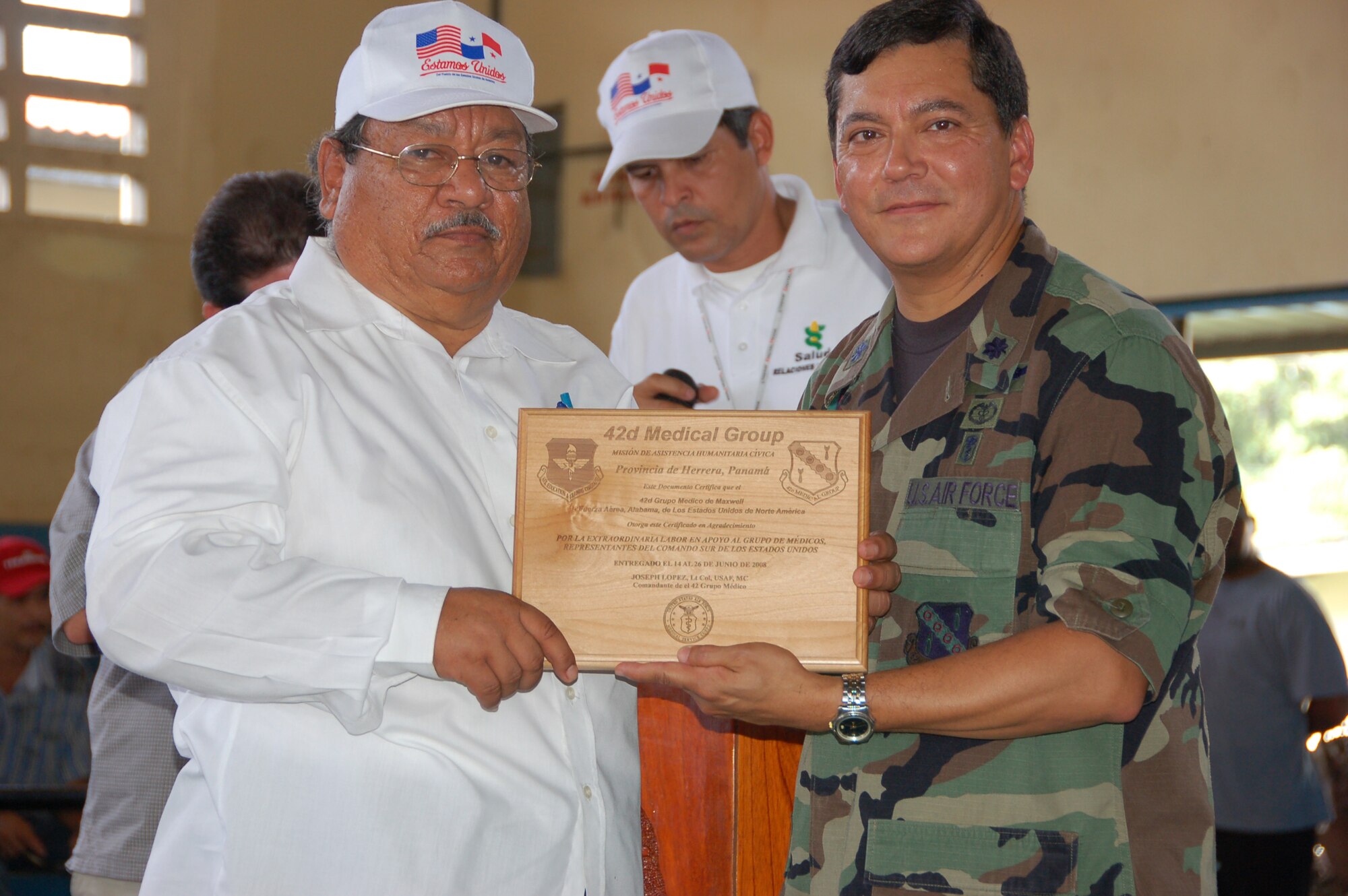 United States Air Force Lt. Col. Joseph A. Lopez, the Medical Readiness Training Exercise Panama Mission Commander from Maxwell Air Force Base, Ala., presents a plaque to Dr. Gonzales the director of the Panama Regional Ministry of Health during closing ceremonies for the MEDRETE July 24  in Pesè, Panama. The MEDRETE is a two-week long U.S. Southern Command sponsored medical exercise designed to hone the skills of medical personnel while providing free health care in remote locations through partnership with host nation doctors. 