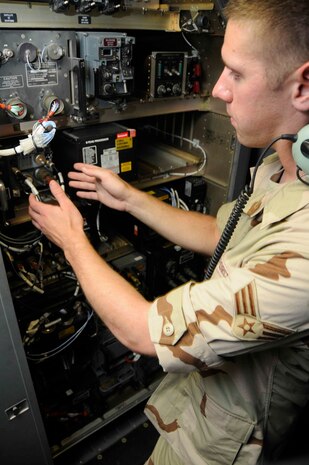 Senior Airman Jon Houghton replaces an ultra high frequency receiver transmitter onboard a C-17 in Southwest Asia. Airman Houghton is a communications, navigations and missions system journeyman deployed as part of the 8th Expeditionary Air Mobility Squadron from Charleston AFB. (U.S. Air Force photo/Senior Airman Domonique Simmons)