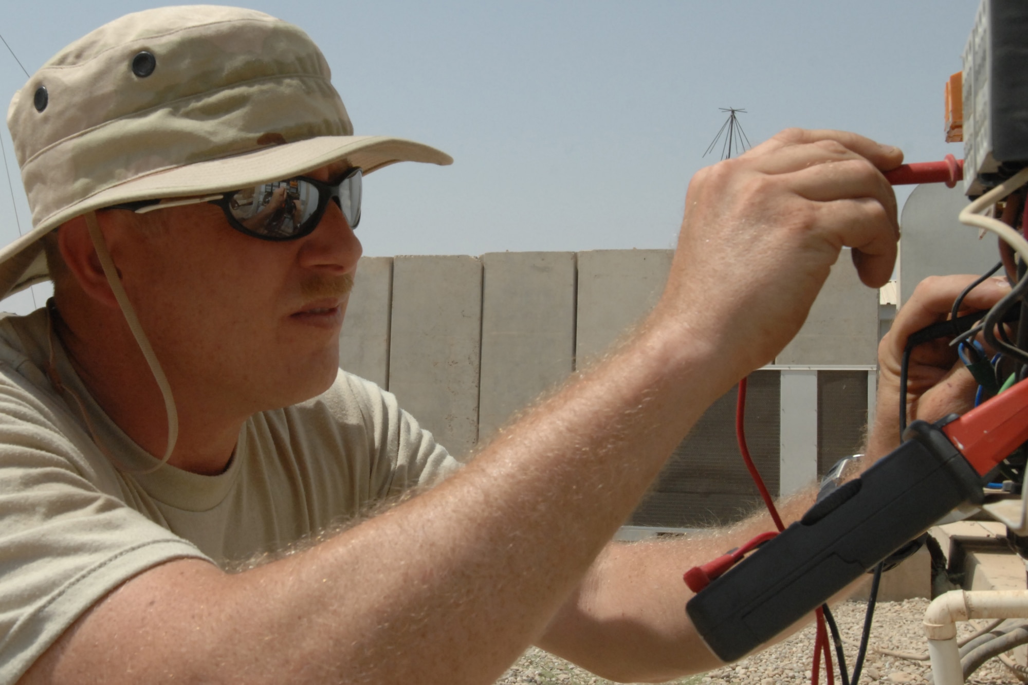 KIRKUK REGIONAL AIR BASE,  Iraq -- Master Sgt. Joseph Moss, 506th Expeditionary Civil Engineer Squadron electrical shop, checks the circuits of the water lift station at the Air Force Village laundromat July 29.  Both pumps at the lift station failed and the combined efforts of the electrical and utilities shops from the 506 ECES had the lift station operating again in less than 18 hours.  An average of 350 loads of laundry are washed at the laundromat and this station moves the grey water to a larger station prior to being sent to the base's water treatment plant. Sergeant Moss is from the 932nd Civil Engineer Squadron at Scott Air Force Base, Ill. (U.S. Photo/Master Sgt. Andrew Leonhard)