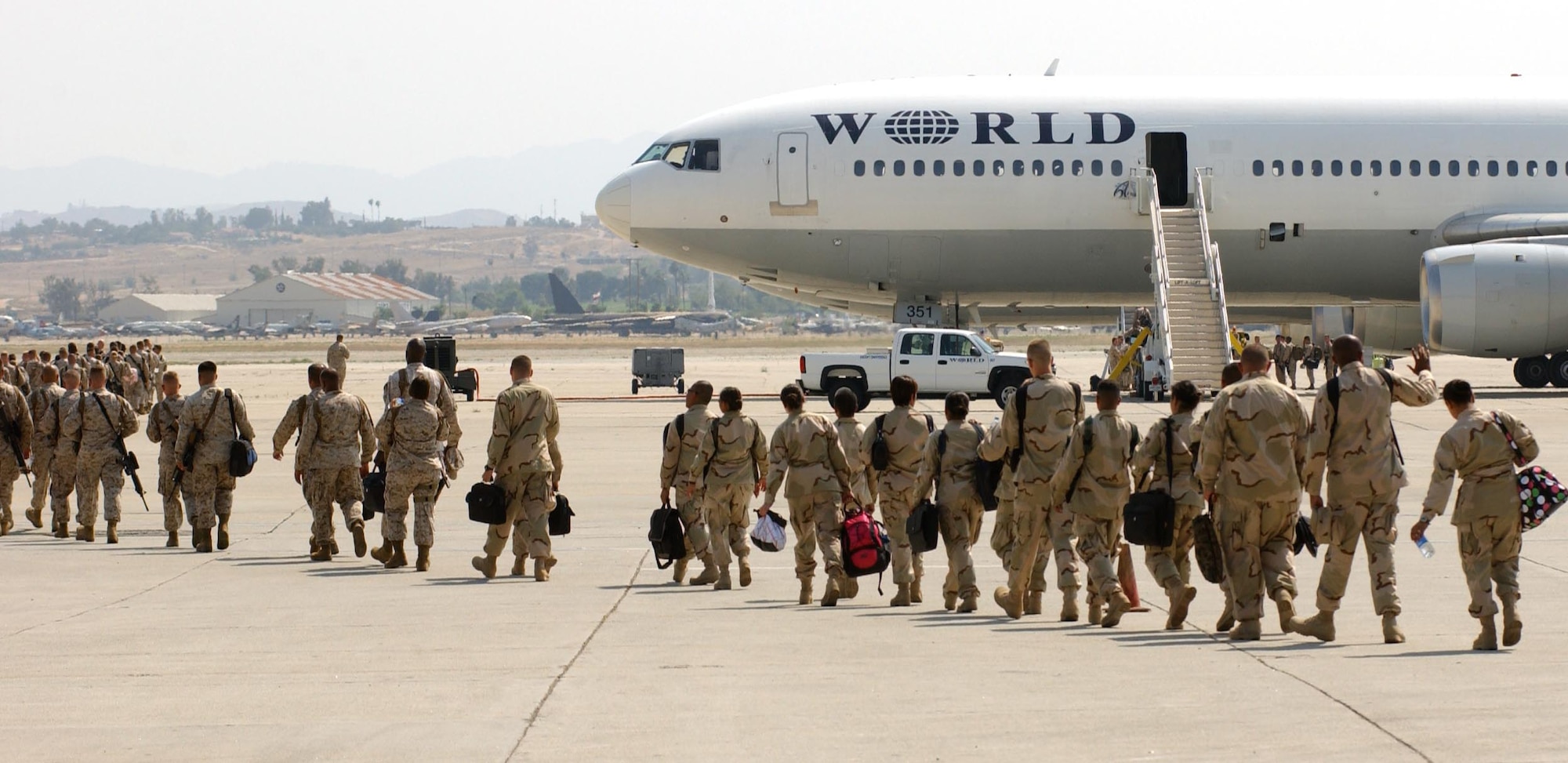 Marines from I Marine Expeditionary Force prepare to board a flight at March Air Reserve Base, Calif., July 13 en route to Iraq. Tens of thousands of U.S. service people pass through the base each year on their way to and from overseas. (U.S. Air Force photo/Senior Airman David Flaherty)