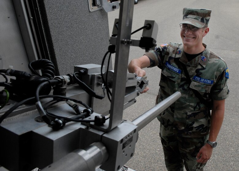 VANDENBERG AIR FORCE BASE, Calif. --  Cadet Chief Master Sgt. Joe Vanherweg, Civil Air Patrol cadet, shakes hands with the F6 robot used for handling explosives during a visit to the 30th Civil Engineer Squadron's explosive ordnance disposal flight.(U.S. Air Force photo/Airman 1st Class Andrew Satran)

