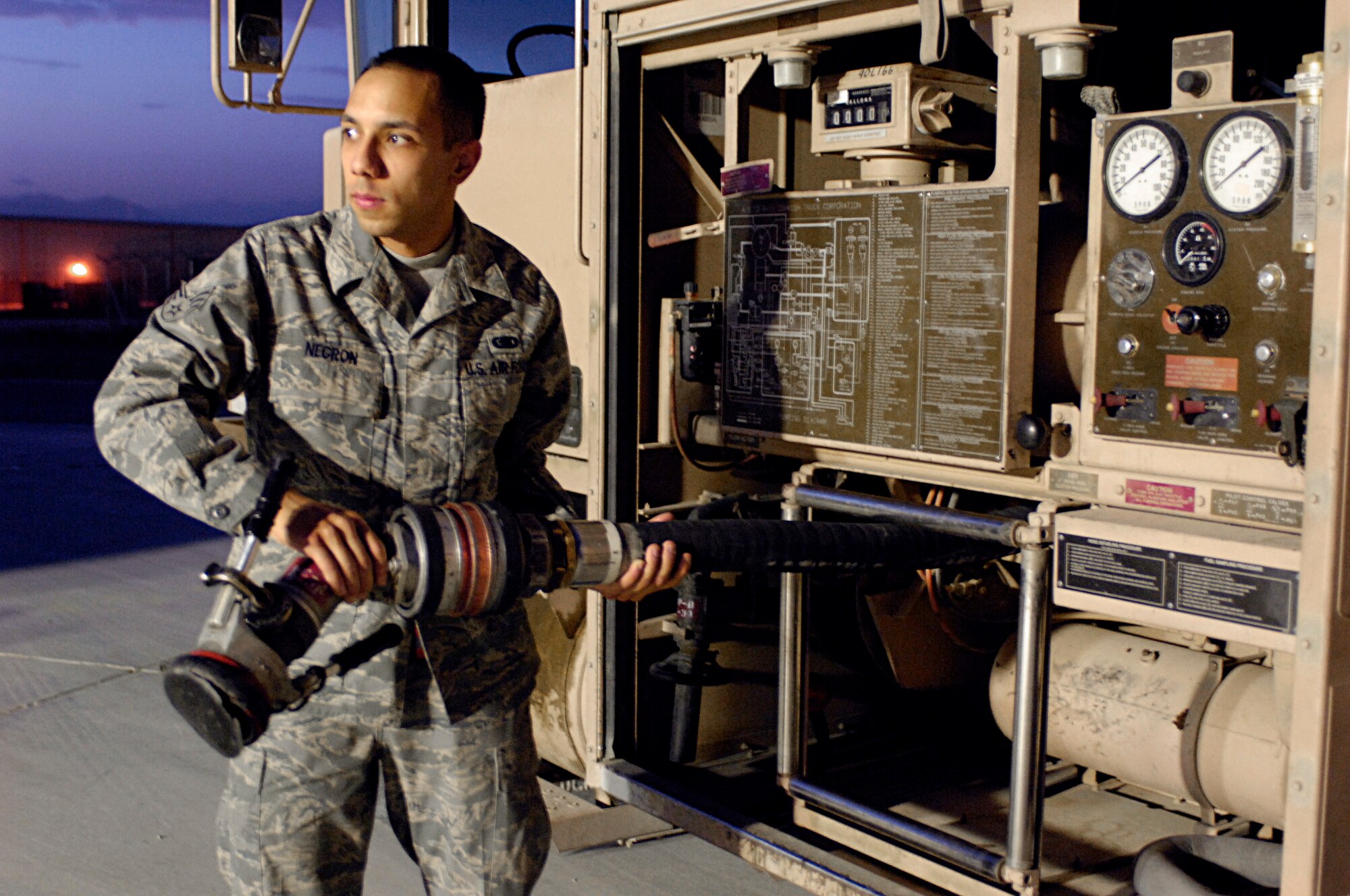 BAGRAM AIR FIELD, Afghanistan -- Senior Airman Ramon Negron, 455th Expeditionary Logistics Readiness Squadron fuels distribution operator, prepares for a refueling run here July 27, 2008. Earlier this month, Airman Negron broke the record for million gallons pumped, doing it in just 61 days. Airman Negron is deployed from McChord Air Force Base, Wash., but calls San Juan, Puerto Rico, home. (U.S. Air Force photo by Staff Sgt. Rachel Martinez)