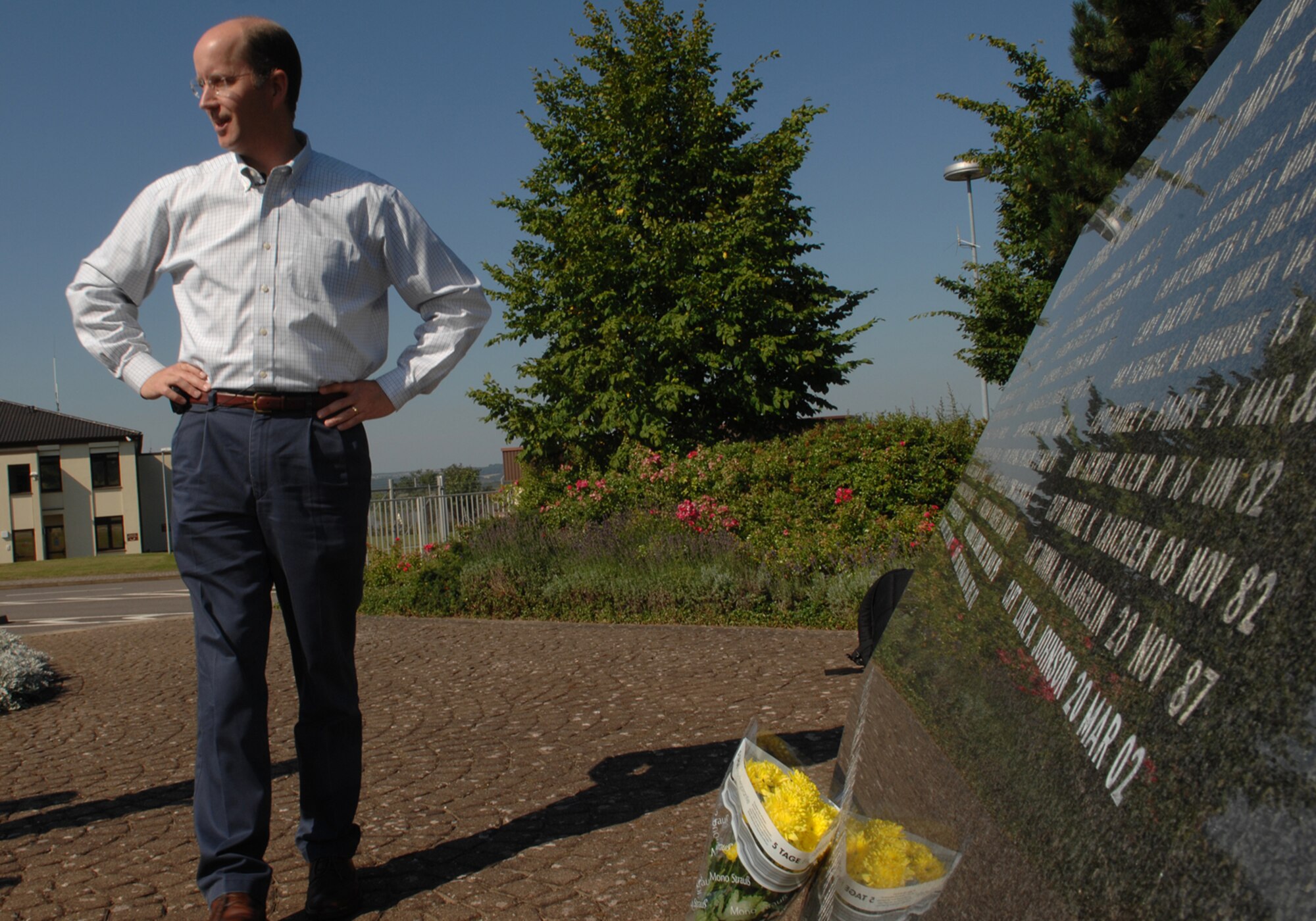 SPANGDAHLEM AIR BASE, Germany--Mr. Clay Skelton, the son of former 52nd Tactical Fighter Wing Commander Col. Richard E. Skelton places flowers July 25, 2008 at the Spangdahlem Airman's Memorial bearing his father's name.  Col. Skelton died from a heart attack during a mission in an F-4 after safely landing his plane.  This was the first time since his father's death that Mr. Skelton returned to Spangdahlem. (U.S. Air Force photo by Senior Airman Logan Tuttle)
