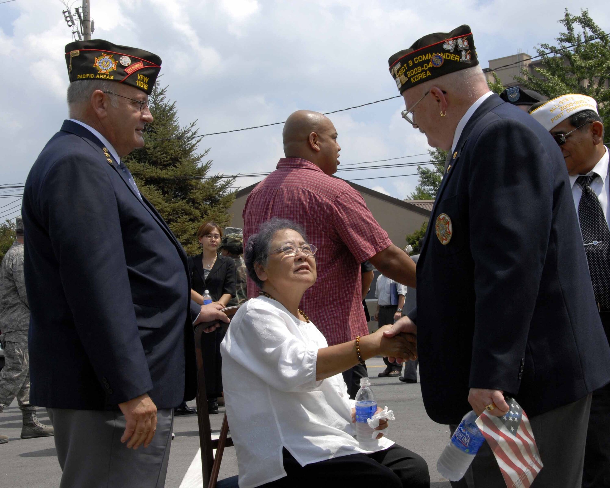 OSAN AIR BASE, Republic of Korea -- Sok Kyun Price, (center), wife of the  late Master Sgt. (retired) James T. Price, receives condolences from members of the local Veterans Foreign Wars Association during a memorial service held for Sergeant Price at the base chapel here July 29. Sergeant James Price was one of the youngest members of the famous Tuskegee Airmen and mentor to the Osan Air Base community. (U.S. Air Force photo/Staff Sgt. Lakisha Croley)