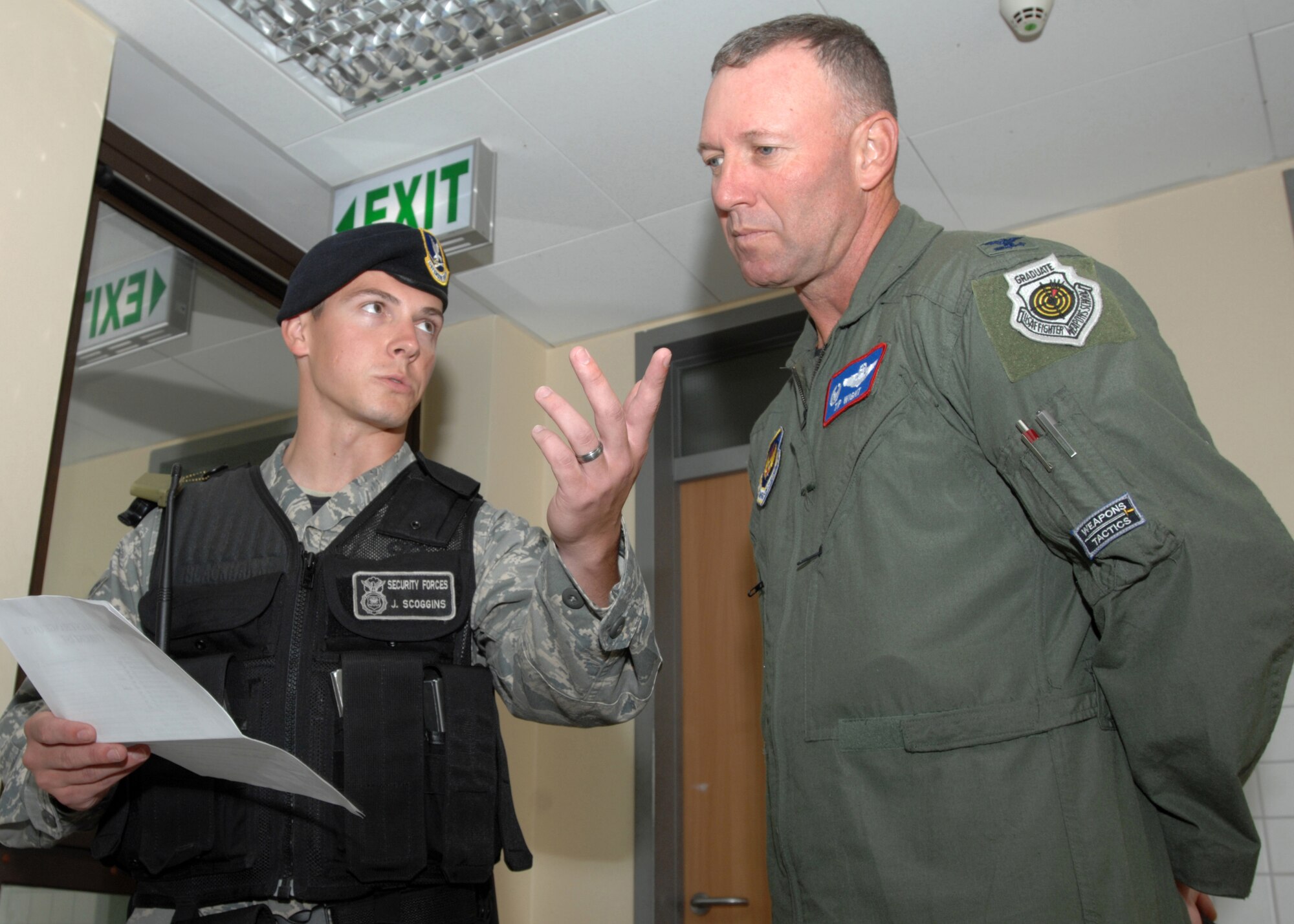 SPANGDAHLEM AIR BASE, Germany-- Airman 1st Class Josh Scoggins, a 52nd Security Forces Squadron Security Forces Journeyman, briefs Col. Tip Wight, 52nd Fighter Wing Commander, on shift change procedures July 28, 2008. Scoggins was the July participant for the Commander's Shadow Program, an ongoing tool used to recognize Spangdahlem's finest Airmen. (U.S. Air Force photo by Airman 1st Class Jenifer Calhoun)