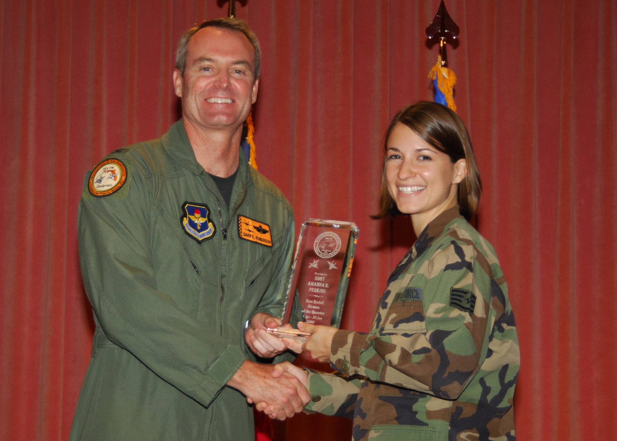 SSgt Amanda Perkins receiving the Tyndall Airman the Quarter award from Col Roberson of the 325th wing at the Quarterly Awards Luncheon July 28, 2008. Photo by Lisa Norman.