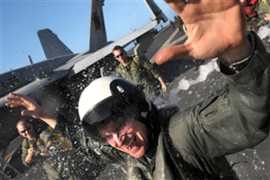 U.S. Navy Capt. Richard W. Rhett Butler gets hosed down after returning from his final flight as commander of Carrier Air Wing 14 on the flight deck of the aircraft carrier USS Ronald Reagan, July 27, 2008. The Ronald Reagan Carrier Strike Group is deployed in the Pacific.