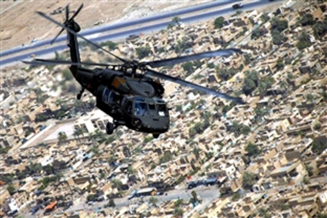 A U.S. Army UH-60 Blackhawk helicopter flies over eastern Baghdad as the command staff of the 10th Mountain Division conducts an aerial reconnaissance of major joint security stations and combat outposts in Baghdad, Iraq, July 25, 2008.  

