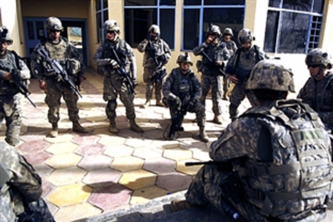 U.S. Army soldiers listen to a briefing for a patrol at Joint Security Station Shula, Iraq, July 18, 2008. The soldiers are assigned to the 101st Airborne Division's Company B,1st Battalion, 502nd Infantry Regiment.  
