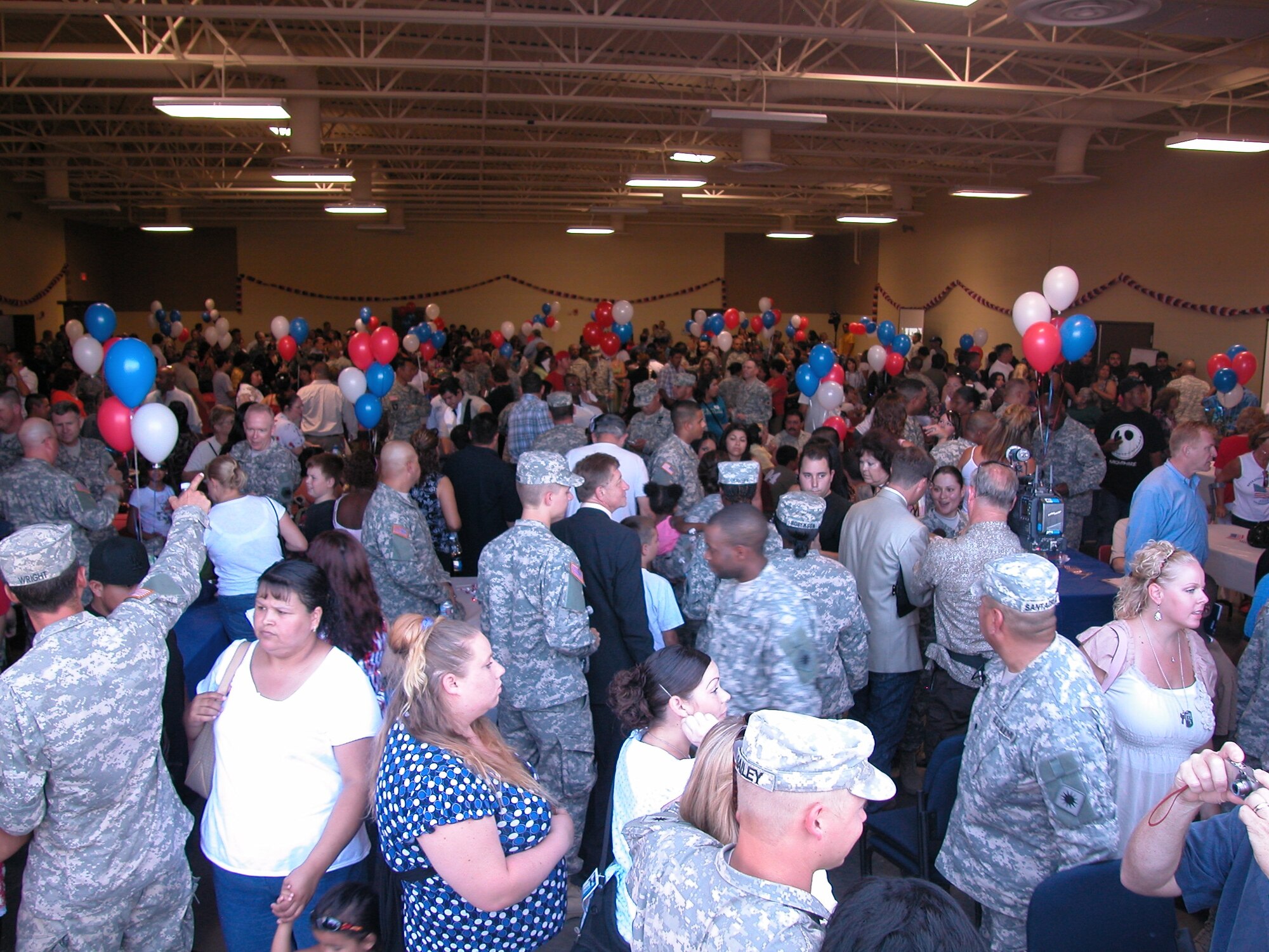 A WARM SEND-OFF: Some 200 soldiers from the 1498th Transportation Company, California Army National Guard, are given a send-off by their unit and the community at March Air Reserve Base as they head out for a one-year deployment in Iraq. More than 700 family members attended the event which will be their last physical contact with the Soldiers until they return in 2009. Brigadier Gen. Keith Jones, Assistant Deputy Adjutant General for California; Wally Rice, representative for Riverside County Supervisor Marion Ashley; Riverside Councilman Steve Adams and Colonel Lisa Constanza, 224th Sustainment Brigade commander, were a few of the guests present. After the formal ceremony, the troops and their families were treated to lunch at their unit while the children enjoyed playing on a bouncer and having a clown paint their faces. (U.S. Air Force photo by Maj Don Traud, 452 AMW/PA