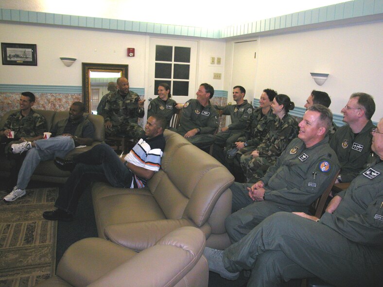 A group of UTAers share a chuckle while watching the comedy “Semi-Pro,” starring
Will Ferrell during the first “Movie Night” in the Cirrus Room at the Hap Arnold Club next to the Pizzeria’s main dining room. The club now sponsors “Movie Night” on UTA weekends. The event was made possible by the Wing Advisory Council, March Top 3 Association and Rising-Six, who approached the club after requests from members on base. Upcoming movies will be posted at the Pizzeria and lodging two days before UTA weekends. (U.S. Air Force photo by Maj. Don Traud, 452 AMW/PA)