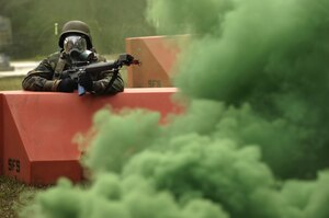 Airman 1st Class Lee Olson participates in a simulated gas attack while doing expeditionary combat skills training on base December 2006.  More than 230 Airmen have participated in the revamped class that started in January this year. Airman Olson is with the 437th Medical Group. (U.S. Air Force photo/Senior Airman Desiree Palacios)
