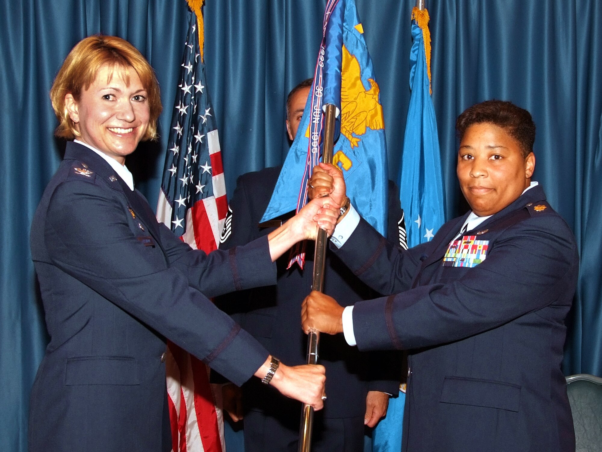 VANCE AIR FORCE BASE, Okla. -- Maj. L. Michelle Stringer, right, accepts command of the 71st Security Forces Squadron from Col. Jennifer Graham, 71st Mission Support Group commander, during an assumption of command ceremony July 30 at the Vance Collocated Club here. (Photo by Terry Wasson)