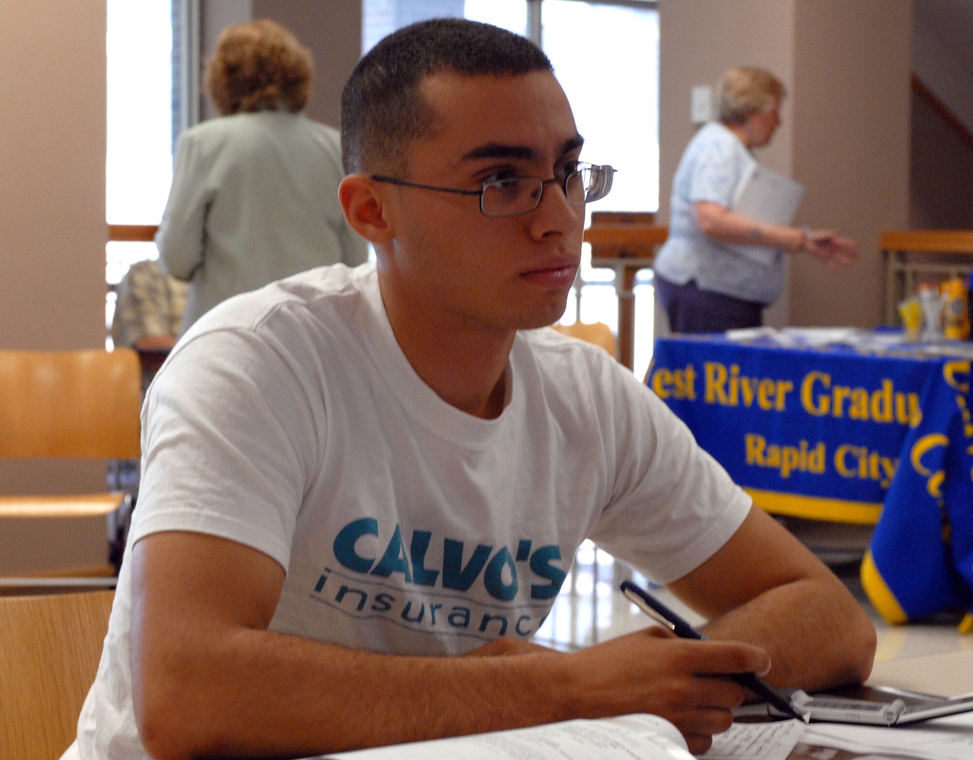 Airman 1st Class Emmanuel Cardenales, 28th Munitions Squadron ammunition technician, learns about ways to earn his bachelor's degree at the 28th Force Support Squadron Education Fair, July 30. Airmen and dependents from across the base were given the opportunity during the fair to explore educational options from nine different colleges and agencies, as well as the Base Education Office, itself. (U.S. Air Force photo/Staff Sgt. Joshua Stevens)
