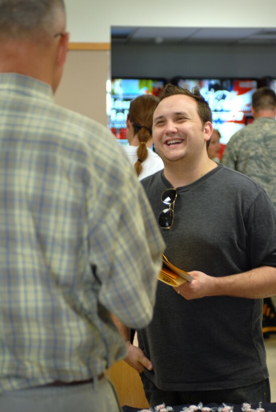 Senior Airman Nate Dennis, 28th Logistics Readiness Squadron Aircraft Parts Store technician, chats with Rick Rhode, Black Hills Area-Veterans Upward Bound program advisor, regarding VUB programs available to veterans during the 28th Force Support Squadron Education Fair, July 30. On top of the wealth of information provided, the Base Education Office offered free lunch and chances to win door prizes to participants of the fair. (U.S. Air Force photo/Staff Sgt. Joshua Stevens)
