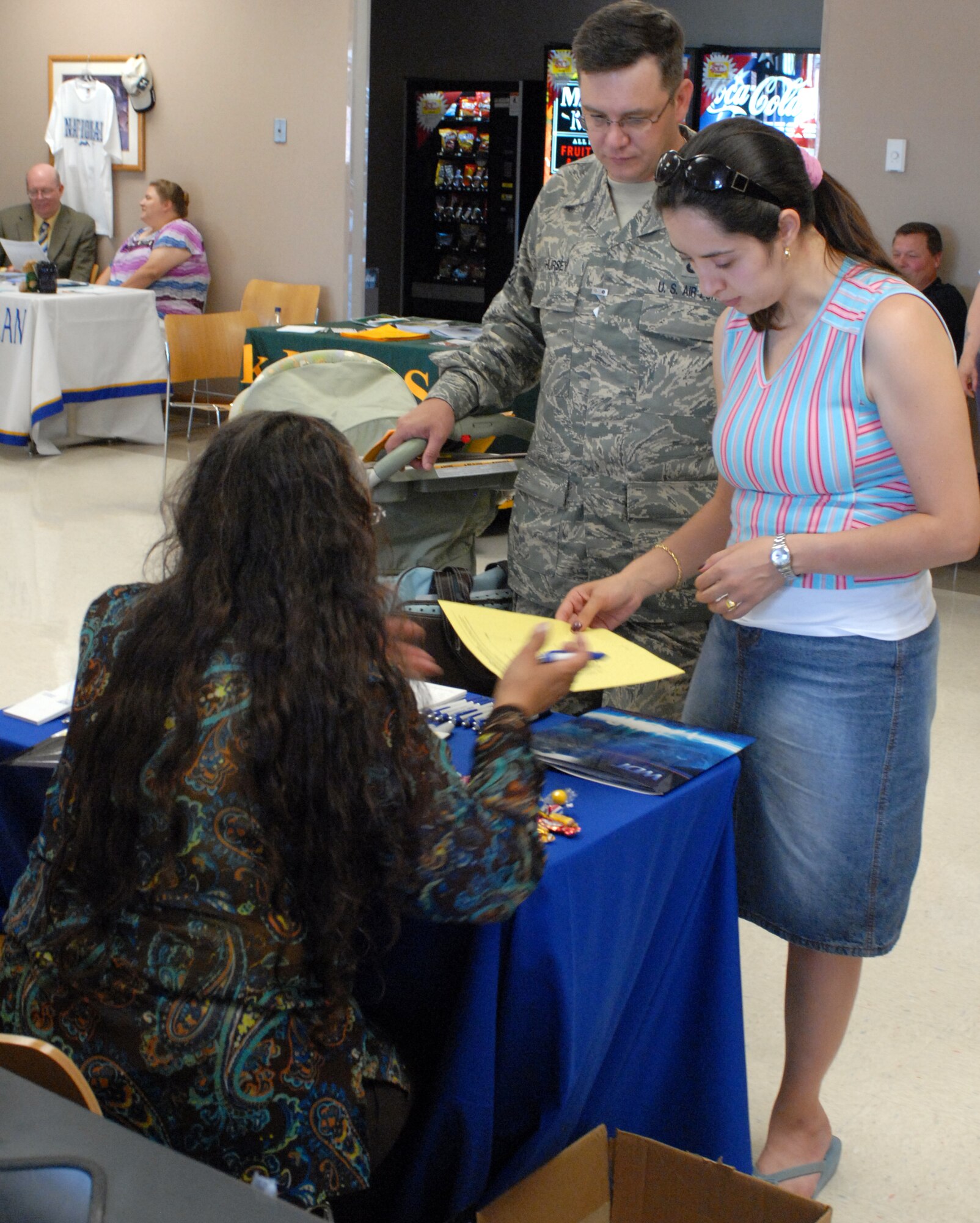 Tech. Sgt. Joe Hursey, Air Force Financial Services Center debt management technician, and his wife, Beatriz, confer with an information provider at the 28th Force Support Squadron Education Fair about educational opportunities for servicemembers and their families, July 30. Base personnel and their dependents were offered information from nine different colleges and agencies during the fair. (U.S. Air Force photo/Staff Sgt. Joshua Stevens)