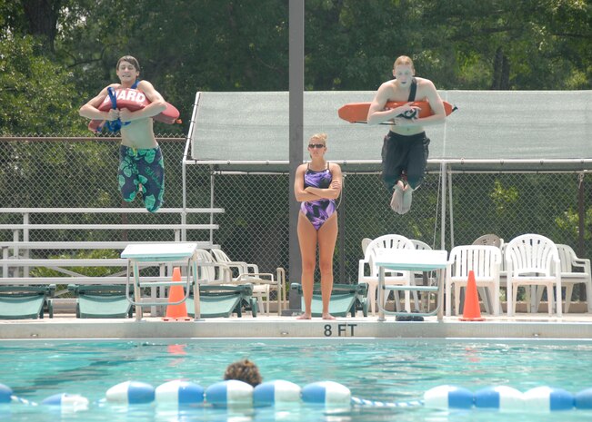 Allison Clayton watches as Stephen Still and Jordan Aarant practice compact jumps into the base pool July 26. The American Red Cross sponsored lifeguard training on base and offered it through the Outdoor Recreation Center. Mrs. Clayton is a lifeguard at the base swimming pool and Stephen, 15, is the son of retired Col. Bernie Still and Jordan, 15, is the son of Kim Muir. (U.S. Air Force photo/Airman 1st Class Cynthia Spalding)