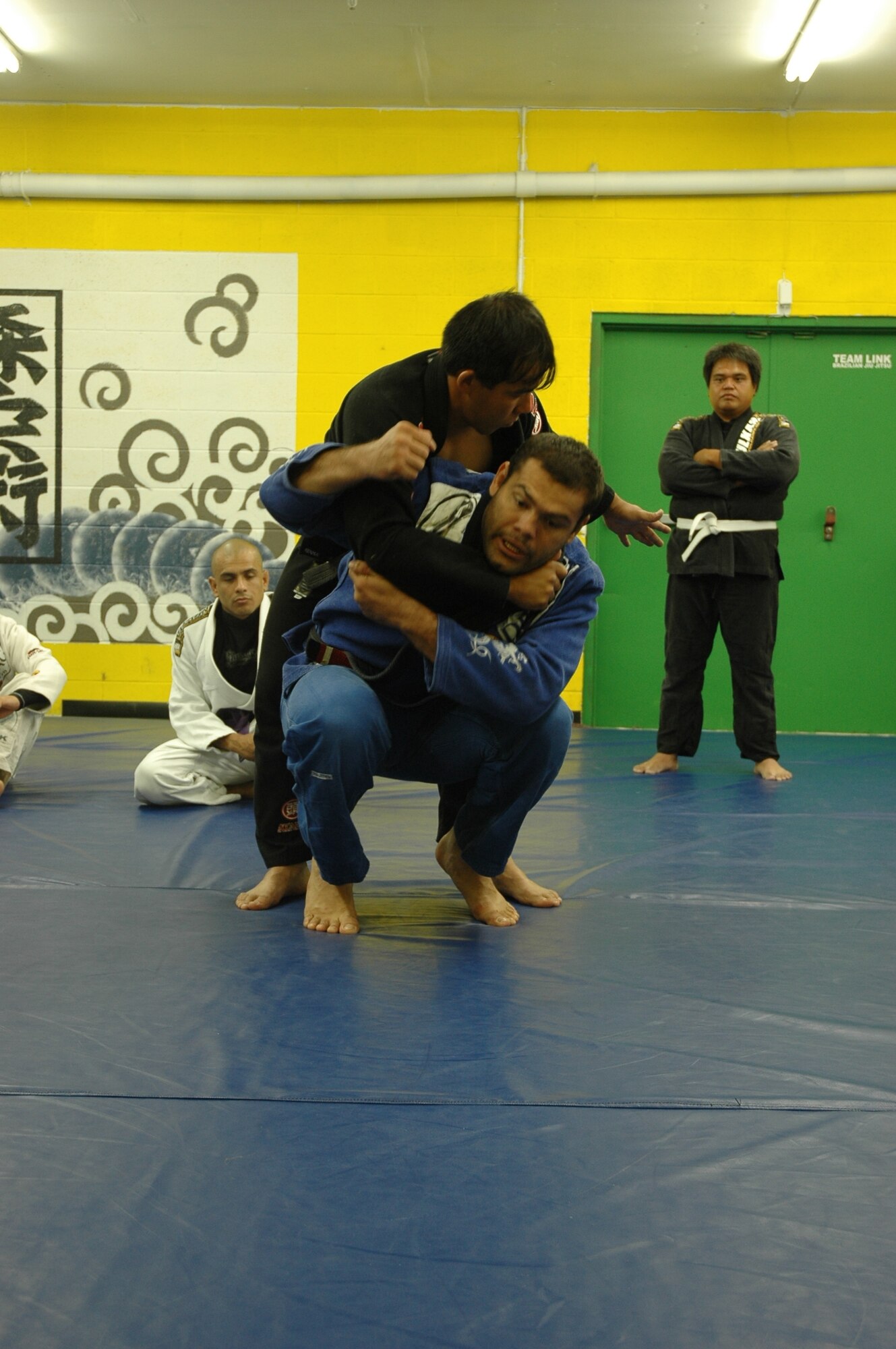 Gabriel Gonzaga, an Ultimate Fighting Championship competitor and Brazilian Jiu-Jitsu black belt, tosses Eduardo Mori, owner of Mori's Academy of Martial Arts and Brazilian Jiu-Jitsu black belt, in an over-the back judo throw at a seminar at the Sunset academy July 26. (U.S. photo by Airman 1st Class Robby Hedrick)